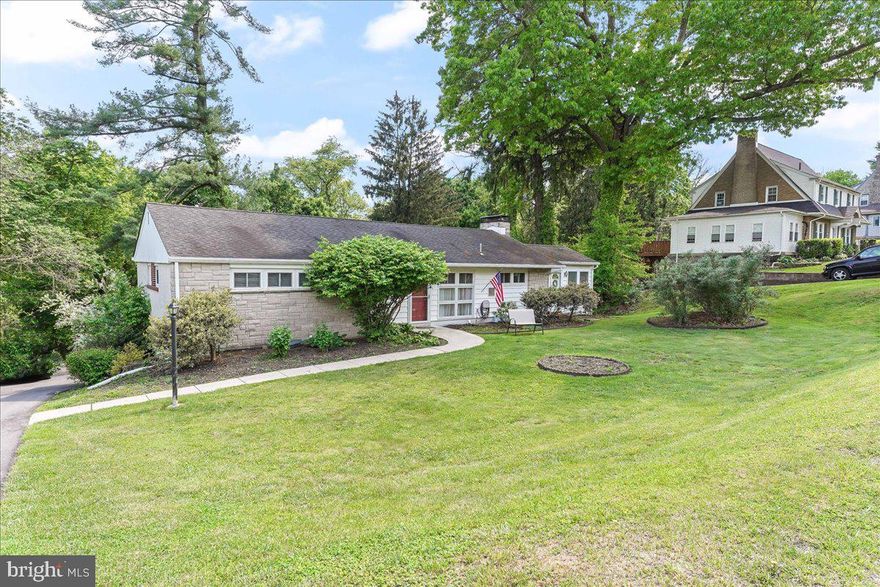 One floor living in desirable Springfield Township! Beautifully situated on a large 105 x 160 lot with views of a flowing rear yard backing up to a wooded area with mature growth.  Boasting over 1750 sq ft of living space, this rancher offers a flexible floor plan to fit your needs! Upon entering you are greeted by the dining room that could be your entrance foyers that leads you into the spacious living room with loads of windows and beautiful views complete with a gas fireplace. The kitchen has been updated with granite counters and an adjoining family room with front door access. Completing the main level are 3 nicely sized bedrooms and hall ceramic tile bath. The basement offers additional living space with even more windows to take in the natural light and views, convenient half bath, spacious laundry/mechanical/storage room, as well as inside access to the large 23x24 two (2) car attached garage. Outside the basement family room is a patio to further enjoy the setting or your next get-together. Additional amenities include large driveway with parking for multiple cars, dimensional shingle roof and replacement windows . Easy access to Routes 1 and 476. Just blocks from major shopping and close proximity to transportation.