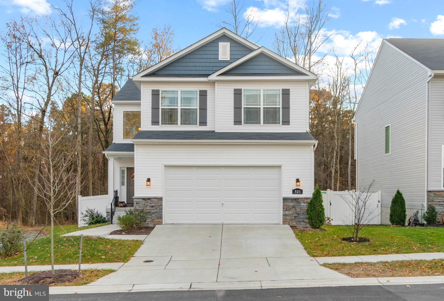**OFFERS ARE DUE AT 5 PM ON THURSDAY, 12/9** Built in 2020, this like-new 5BR/3.5BA home sits on a prime corner lot and features a nicely fenced backyard and large two car garage. You’ll love the spacious floor plan on the main level with a living room, separate dining room, eat-in kitchen, and powder room. Enjoy the wide plank hardwood floors, tall ceilings, and great natural light throughout. The open and modern kitchen features granite counters, stainless appliances, white shaker cabinets, and breakfast bar. Off the kitchen, there is access to your private fenced backyard that overlooks a quiet wooded area! Upstairs, there are four spacious bedrooms, including a huge primary bedroom suite with an organized walk-in closet, area for a home gym or office, and a full en-suite bathroom with a relaxing soaking tub, double vanity, and shower. There’s also an additional full bathroom and laundry room with a full-sized washer and dryer on the upper level to make laundry a breeze. The completely finished lower level has a very large bedroom, full bathroom, walkout access to the backyard, and additional living space that is perfect for entertaining or a home office. The home is situated on a prime lot within the well-maintained community and has a low monthly fee. Enjoy the easy access to I-97, several parks, and more! Hurry, you don’t want to miss this one!