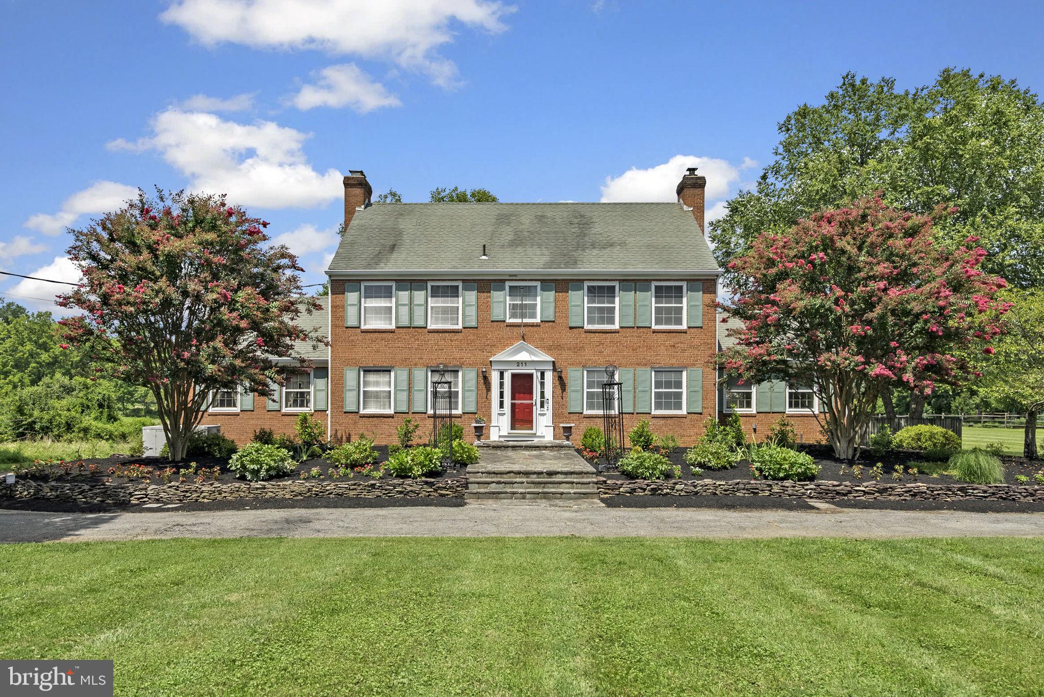 Incredible, stunning, and expansive are just a few of the words that come to mind when describing this property. Curb appeal is evident as you enter the tree-lined drive. Ample parking with a wrap-around driveway that takes you from the front of the home, all the way around back before bringing you back where you started. Once inside, you will notice the hardwoods throughout the main level. The cozy living room features views of the yard and a brick-surround fireplace. The spacious kitchen has ample prep space, granite counters, stainless steel appliances, and gorgeous wood cabinets. The family room has a second fireplace with a wood-burning stove insert. Upstairs, you will find a gorgeous primary suite with an updated bath, large windows, and a generously sized walk-in closet! The lower level is perfect for spreading out and entertaining! Just out back, you will find a fenced-in yard, but don't forget to walk the property behind the attached garage to check out all the LAND this property has to offer! In addition to the 2-car attached garage (rear load as not to take away from the stunning front fascade), there is an additional 6-car detached garage for all your vehicles, yard equipment, and anything else you could imagine! Convenient to all major commuter roads, steps from the local high school, shops, and dining, you won't want to miss this one! Call for your private showing today!