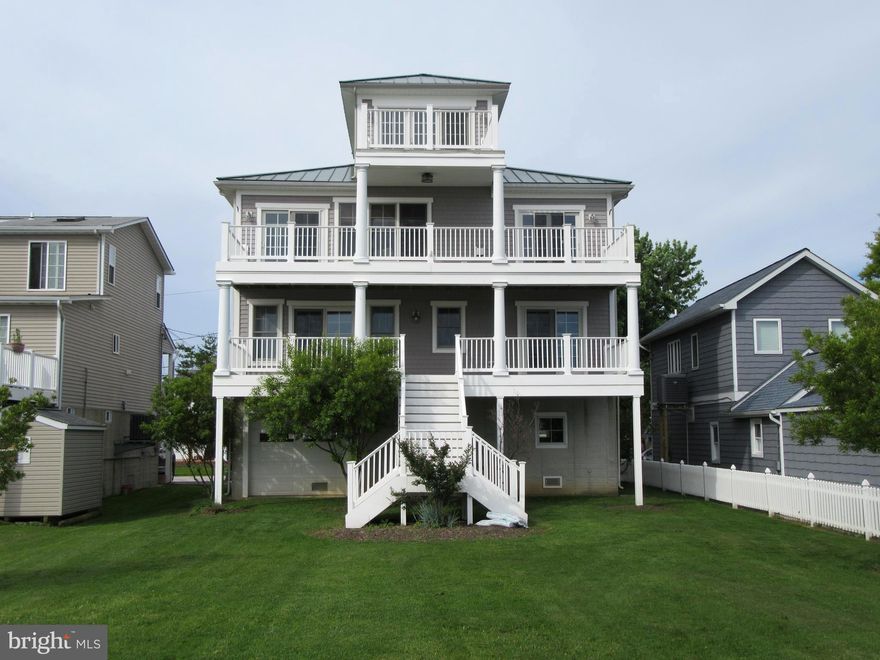 Stunning views of the  Chesapeake Bay and Patapsco River. Spiral staircase leads to the Cupola with roof top views of  Hart Island . LR located on 2nd level  has gas F/P, hardwood floors,  gourmet kitchen with  granite, SS appl,42 inch cabinets +breakfast bar.  Master bedroom located on main level has a huge walk in closet  also a fantastic master bath with double bowl sinks . ELEVATOR for all 3 levels( 2504 sq ft  spacious 2 car garage, bulkhead and  pier are a plus with a great level yard.