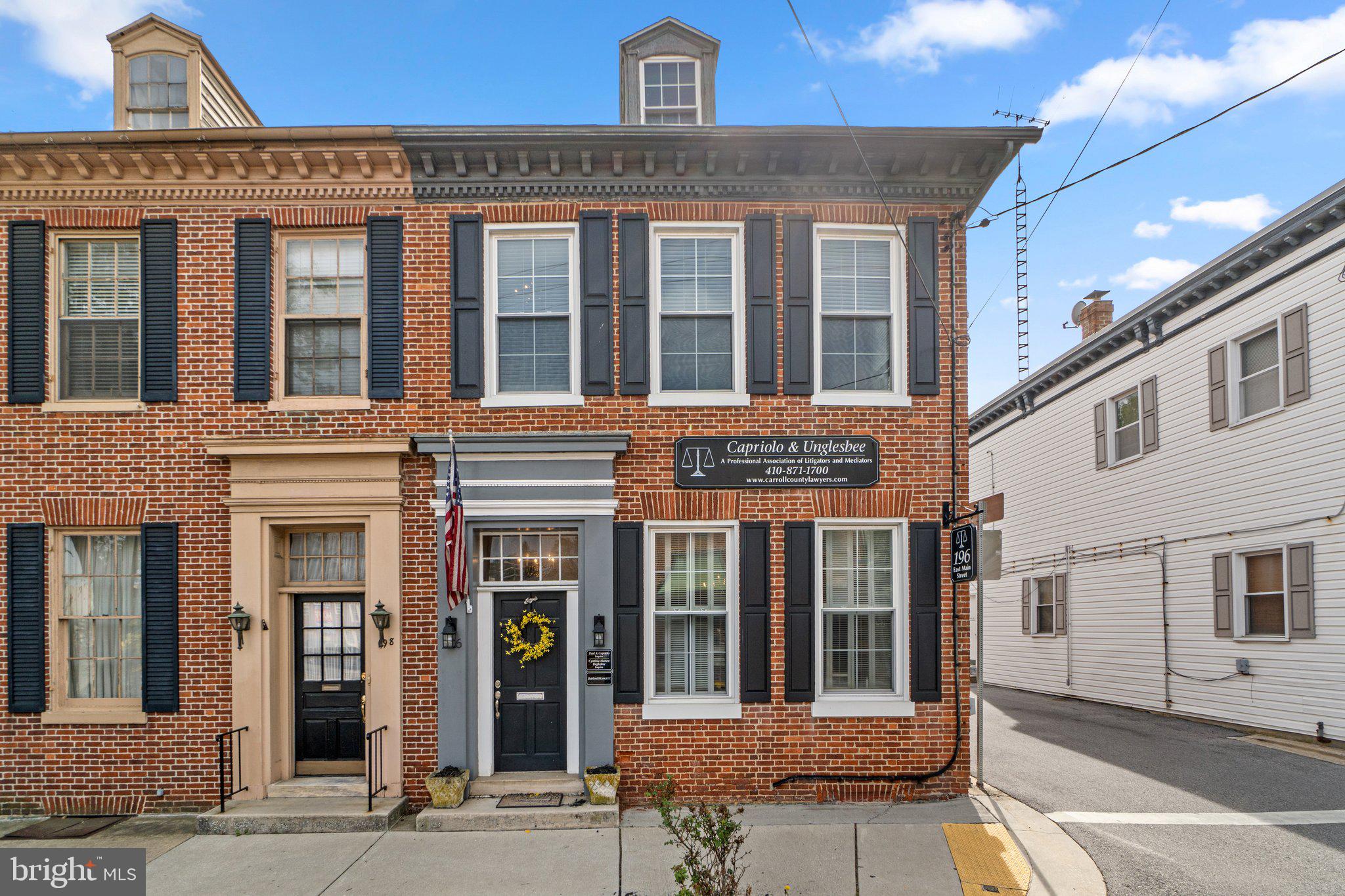 PRICE IMPROVED $35K READY TO SELL! Prime Commercial Office with Private Rear Parking | 196 E. Main St., Westminster, MD 21157. Currently operates as a law office. Exceptional end-unit rowhome in the heart of downtown Westminster! This versatile commercial property offers 4/5 private offices/bedrooms, including 1 on the main level, 2 bathrooms, and 2 entrances— 1 of which is handicap accessible with designated handicap parking. Situated just 1 block from the old historic courthouse and 3 blocks from the main courthouse, the location is ideal for legal, professional, medical offices, or small business. Enjoy the enduring charm of exposed brick accent walls, permanent stone foundation, and classic architecture, blended seamlessly with modern amenities including central A/C, natural gas heat, and a private 10-spot paved parking lot—a rare downtown find. Recent upgrades include a new HVAC system (2023), newer windows (2017), and water heater (2017). Additional dry attic and basement storage provide ample room for files, supplies, or equipment. Walkable to restaurants, shops, and local businesses—this is a unique opportunity to own a character-rich, highly functional office space in one of Westminster’s most desirable commercial corridors.