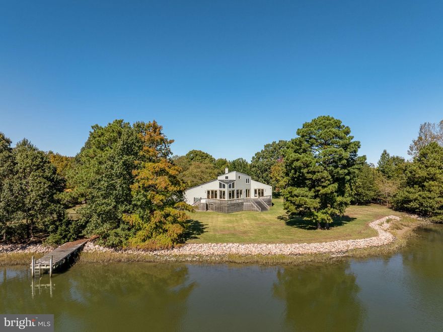 An amazing opportunity and first offering of this architectural gem situated on nearly 2 acres with stunning views of the Chesapeake Bay. New Roof 2021! A fantastic open floorplan featuring a stunning foyer with a statement staircase, floor to ceiling water views in the living room and amazing storage in the contemporary style kitchen. Wake up to the serene waterfront in the main level primary bedroom with vaulted ceilings, a massive closet and ensuite bath with dual sinks. Another bedroom, a well-sized office, a powder room and an additional utility room with main floor laundry complete the first floor. Upstairs, two additional bedrooms share another full bath. Additional storage and cedar closet above the huge three car garage! Outside, the extensive deck and private pier capture all the possibilities this amazing waterfront home can offer!