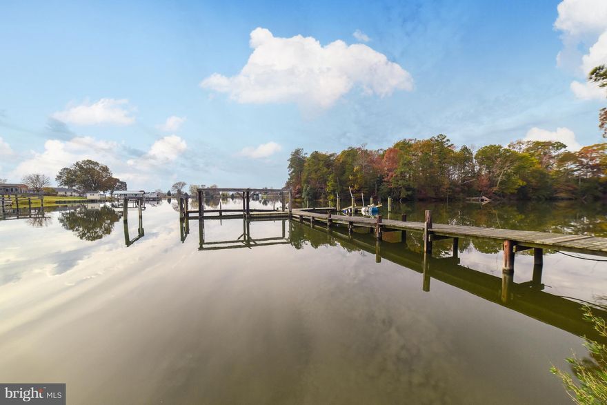 1.1 acres of great waterfront!!  Seller is having dock rebuilt. Driveway was just paved. Home has 4 bedrooms, 2 on main level and 3 full baths that have been beautifully updated. .  Gleaming hardwoods throughout home.  Kitchen features granite counters and stainless steel appliances.  Three season room on waterside  to enjoy the full view of Herring Creek.  One car attached and one car detached garage, with extra space perfect for workshop.  Completely move in ready!!