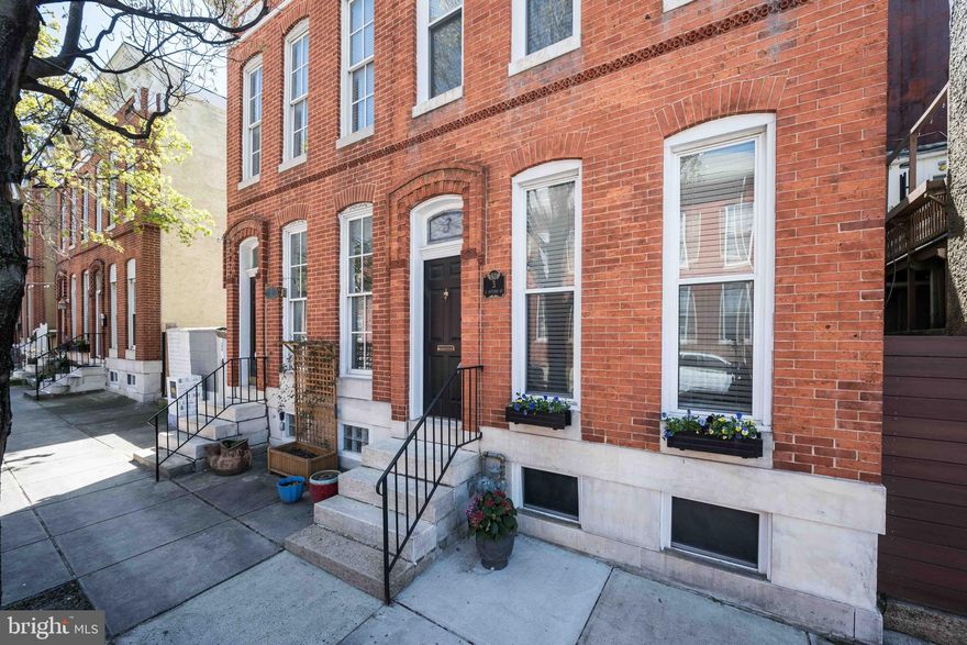 Federal Hill: Historic Charm & Modern Convenience

Enjoy the stunning original stained-glass transom window as you step through a classic Baltimore vestibule entryway—a practical and charming local tradition—into this beautiful end-unit Federal Hill row home. The home is flooded with natural light and perfectly balances historic character with modern updates. It features some 10-foot ceilings, main level refinished hardwood floors, replacement windows, and a beautifully detailed staircase.

Entertaining is easy with a modernized kitchen with granite countertops and a convenient main-level half-bath and laundry. Upstairs, the flexible floor plan is highlighted by original pine flooring, exposed brick, and a beautifully reglazed clawfoot tub. An unfinished basement offers plenty of storage space. This home has it all.

Outside, your private enclosed courtyard serves as a quiet sanctuary for dining and relaxing.

Located in the heart of the neighborhood, you are just steps from Cross Street Market and the area’s renowned local dining and shops and  easy access  to Federal Hill Park and the Inner Harbor.