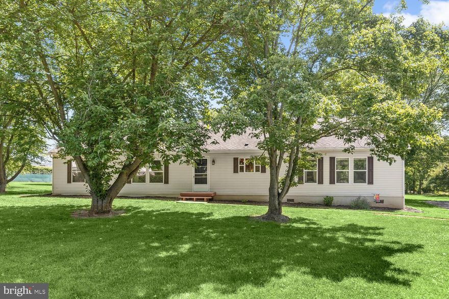 Spectacular 3-bedroom, 2.5-bath ranch style home with a pole barn perfectly sited on a beautiful 2-plus acre lot!    You’ll be captivated as soon as you arrive into the gleaming all-season sunroom embellished with rich, hardwood floors and a stone surround gas fireplace extending a warm welcome to all.  Step through one of the graceful arched entryways to the dining area that flows seamlessly into the expansive kitchen where your culinary skills are sure to shine boasting an impressive center island, gas cooking, decorative backsplash, and display cabinets.   Catch up on your favorite streaming shows in the spacious living room complemented by plush carpet and a second stone surround fireplace offering an inviting ambiance year-round.  Retreat to the primary bedroom suite highlighted by an impressive personal bath with a jetted soaking tub, dual sink vanity, ample wall cabinets, and storage, and a separate water closet for additional privacy. Two additional bedrooms, full bath, and a laundry room complete this amazing home! Create your backyard oasis beginning with the barbeque-ready composite deck overlooking the expansive rear grounds offering plenty of room for so many outdoor activities.    Accommodating your cars, lawn equipment, tools, bikes, seasonal items, and even a boat will be a breeze in the adjacent 32x30 pole barn with running electricity and 14 ft. ceilings! Recent updates include hardwood floors in the all-season sunroom, dishwasher, washer, ceiling fans, carpet, and front entry decks.   Enjoy the convenience of rural living close to so many activities such as the new Darlington Library, The Grove, walking trails, and playgrounds in addition to the proximity to the restaurants and shopping of Bel Air plus just a short drive to Pennsylvania.  This home has it all!