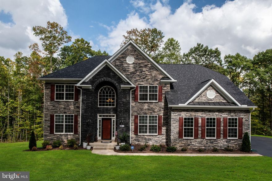 Welcome to your luxurious newer home on 5.42 acres! This stunning gem, built in 2023, boasts a full stone front, adding a touch of elegance to its exterior. With a 2-car side load garage, convenience is at your fingertips. The residence offers an impressive 4,208 square feet of living space across the main and upper levels. Additionally, the unfinished basement, which features a walkout, presents a fantastic opportunity for new owners to customize and complete to their specifications.

Indulge in the serenity of the master bedroom, featuring a trey ceiling in both the bedroom and the sitting room. These subtle architectural details elevate the ambiance of your personal sanctuary.

The kitchen is adorned with sleek stainless steel appliances, combining style and functionality seamlessly. Throughout the home, enjoy flooring and tile upgrades that showcase exquisite craftsmanship and attention to detail.

Unwind in the master bathroom, where a freestanding tub awaits, creating a luxurious retreat within your own home.

Situated on a premium lot, this home offers a prime location within the community, providing privacy and a sense of exclusivity.