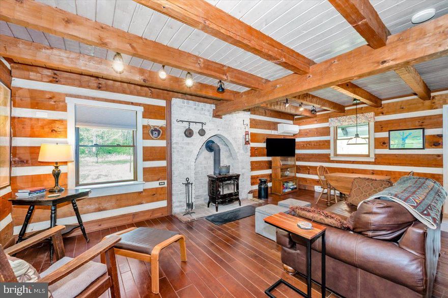 Tucked away on over 12 tranquil acres in the heart of Sharpsburg, Maryland, 16926 Sprecher Road is a rare gem—a secluded country retreat that seamlessly blends natural beauty, and modern comfort. This one-of-a-kind property isn’t just a home; it’s a lifestyle. whether your a homesteader, a Nature person or simply someone craving peace and privacy, this extraordinary haven delivers.

The centerpiece of the property is a stunning log cabin, thoughtfully designed with character and warmth in every corner. From the moment you step inside, you're welcomed by soaring ceilings, rustic wood beams, and the comforting crackle of a wood stove. The open main level invites connection, featuring a charming kitchen with a center island, a cozy dining area, and a light-filled living space perfect for unwinding. Upstairs, the private primary suite offers treetop views and an en-suite bath, while the walk-out lower level provides flexibility—ideal for guests, a home office, or even a studio—with an additional full bath, laundry, and a cleverly integrated Murphy bed.

Just steps away from the house is, a fully finished and climate-controlled Shed/Cottage.  A detached barn and multi-use outbuildings offer endless possibilities for hobbies, storage, or small-scale farming.

The land itself tells a story—part wooded, part open, and entirely peaceful. You'll find a fenced garden with raised beds ready for your harvest, and perhaps Maryland’s largest Chinkapin Oak Tree standing proudly near the edge of the forest, an ancient guardian of this special place. Deer and turkeys frequently wander by, and the soft rustle of leaves in the breeze provides the soundtrack to your days.

Located just minutes from Antietam Battlefield, the C&O Canal, and the historic charm of Boonsboro and Shepherdstown, this home offers the serenity of rural living with easy access to local culture, recreation, and commuter routes. Yet once you arrive, you may never want to leave.

Offered at $625,000, 16926 Sprecher Road is more than a home—it’s a once-in-a-lifetime opportunity to own a slice of soul-soothing countryside, where every detail has been curated for those who appreciate privacy, creativity, and the quiet joy of living in harmony with the land.

If you’re ready for something truly different, come experience this remarkable retreat for yourself.

DO NOT DRIVE BY THE PROPERTY UNLESS YOU HAVE AN APPOINTMENT!!