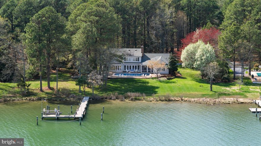 Private Harris Creek waterfront with pool, pier boat lift and deep water access—ideal for boating kayaking and quiet days on the water. Five bedrooms and three-and-a-half baths designed for a relaxed yet refined Eastern Shore lifestyle.
 Featuring  sun-filled interiors feature red oak floors custom built-ins multiple fireplaces and wide water views. The kitchen is designed for gathering with KitchenAid appliances granite counters a butler’s pantry dry bar and an oversized island Main-level living includes a waterside primary suite with fireplace and a private guest suite along with a flexible office or den.Upstairs offers three bedrooms a full bath and a spacious family room.
A screened porch expansive deck. saltwater pool and firepit patio create inviting outdoor spaces overlooking the water. Two-car garage with workshop whole-house generator and new septic system (2025).
An exceptional waterfront offering just minutes to St. Michaels and Easton.