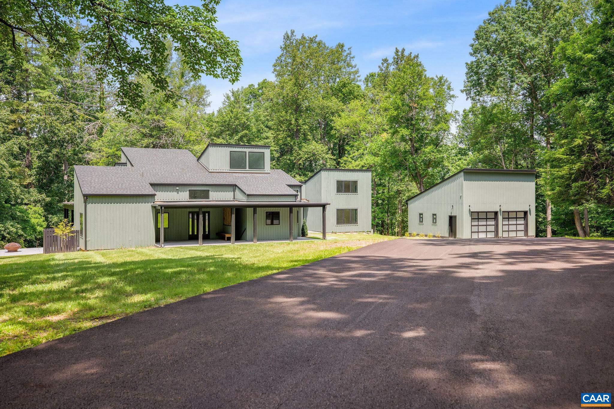 Stunning, completely renovated architecturally distinguished modern contemporary home on 11.05 acres with bold Blue Ridge winter views! Flawless upgrades & renovations have taken this exceptionally well-built, architectural gem to a supreme level of style & quality. The home features beautiful high end finishes throughout with 5 bedrooms, soaring interior spaces, 2 first level primary bedrooms (one guest suite). 2nd level offers 3 bedroom, 2 bath (one en-suite) with multiple space for the creative. Enjoy coffee, drinks and dinner on any of the 4 porches including one large covered wrap around porch. Gorgeous new kitchen features premium custom cabinets (Viking appliances) that connects seamlessly with the open great room, the cozy family room, wet bar and the outdoor spaces. The second primary suite (guest suite) with second floor office/workout is separate but connected via glass walkway to the great room and kitchen. The great room with a beautiful fire place as its focal point is perfectly complemented by the cozy family room with its own fire place. Great room, family room and primary suite all connects to the covered porch. Located on 11+ private acres off Garth Rd surrounded by land in conservation.,Quartz Counter,Wood Cabinets,Fireplace in Den,Fireplace in Great Room