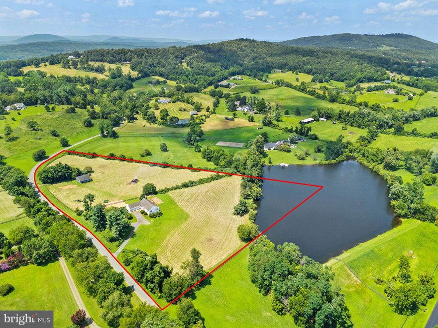 Rare opportunity to own in Bellevue Farms  for under $1M. The star of the show here is  the wonderful land - 10+-acres of gently rolling pasture with pond and board fencing! Beautiful views across neighboring farms. The most perfect little barn currently has 2-stalls with room for 2 more. Center aisle with hot and cold water, wash rack and tack room. Home has been meticulously maintained by the original owner and can be moved into exactly the way it is and then updated over time. Main level living features 4 bedrooms and 2.5 baths up and walkout lower level with full bath. Laundry hookups available in the main level mud room. Large living room made cozy by the gas "wood stove". Huge deck and covered porch (with outdoor shower) overlooking the property.  Propane generator.  With community stable,  community pool and miles of riding trails, it's an idyllic country package for the casual equestrian close to wineries, breweries and more! Starlink is believed to be available but should be verified along with sq ft.