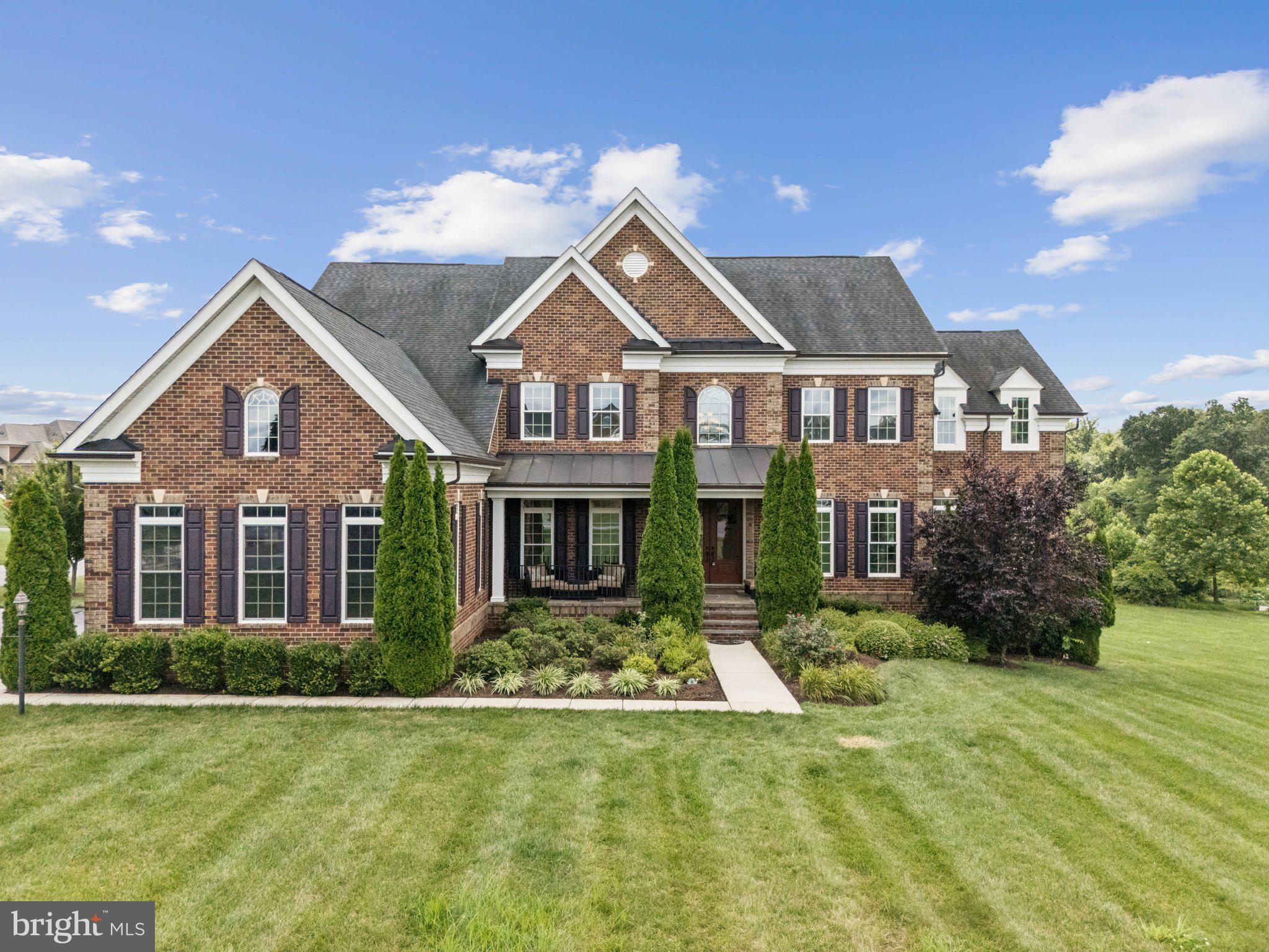 Welcome to 5025 Bee Frances Way, a stunning colonial masterpiece set on a premium 1-acre corner lot in the exclusive Greenberry community—an intimate enclave of just 25 estate homes built by NV Homes.
Constructed in 2016, this expansive residence offers approximately 9,000 square feet of finely crafted living space, including 7 spacious bedrooms and 6.5 bathrooms, perfectly suited for multi-generational living, elegant entertaining, and everyday luxury.
Enter through a dramatic two-story foyer, flanked by formal living and dining rooms. The heart of the home is the impressive two-story family room, flooded with natural light from floor-to-ceiling windows, and seamlessly connected to a gourmet eat-in kitchen featuring two oversized center islands, high-end appliances, and custom cabinetry.
Step outside to the covered rear porch overlooking a lushly landscaped backyard enhanced by mature trees and a mini fruit orchard—an ideal setting for relaxation or entertaining.
The main-level owner’s suite offers a tranquil retreat with a spa-like en suite bath. A second owner’s suite upstairs features a large sitting room, an oversized walk-in closet, and a private balcony with sweeping views of the grounds.
Additional highlights include:
+ A private home office with French doors
+ A functional mudroom with built-in storage, a walk-in pantry, and dedicated main-level laundry
+ A second upstairs laundry room for added convenience
+ A fully finished walk-out lower level with a 7th bedroom, expansive wet bar, full bathroom, home theater, and large recreation area
+ An attached 3-car side-load garage
Ideally located in one of Howard County’s most desirable neighborhoods, this exceptional home is just minutes from award-winning schools, shopping, and commuter routes to the greater Baltimore-Washington corridor.
Don’t miss your opportunity to own this extraordinary estate in Clarksville’s coveted Greenberry community—where luxury meets lifestyle.