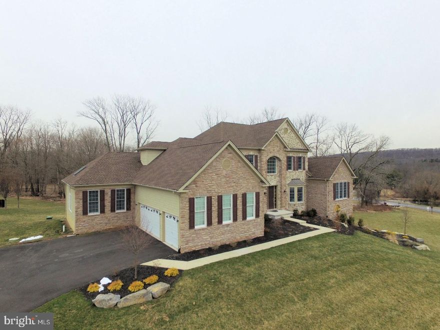 Located in Upper Makefield's most sought after and prestigious new construction community of Dutchess Farm Estates, this spectacular Toll Brothers Covington Heritage model sits prominently on a premium high lot with unparalleled views of Jericho Mountain and the property's original farmhouse with 38 protected acres as your front view. Just 3 years old, this property provides a timely opportunity for you to move right in to this now completely sold out 67 lot estate community. The stately brick/stone front elevation with Hardie Plank is a classic for-the-ages look with a European Country flair. The Covington is Toll's magnificent first floor Master Suite plan featuring a spectacular open foyer entry with curved staircase with dark oak treads and railing and gleaming white spindles. This home has been uniquely customized and is different than anything you have seen from this builder, with impressive 10' first floor ceilings, detailed crown & box moldings, as well as beautiful dark hued 5" walnut hardwoods, marble floored foyer entry. To the right is a open living room & dining room, to the left your office/library. The Master Suite is worthy of a luxury resort, with vaulted ceiling, sitting room with mountain views, luxurious bath consisting of free standing tub, giant shower with multiple heads, radiant heat tile flooring & two walk-in closets w/built-ins. The spectacular gourmet kitchen features 42"custom made walnut cabinets, radiant heat tile floors, granite counters, Wolf, Sub Zero and Miele appliances, pot filler, large center island & oversized breakfast room with deck access. The family room features a wall of windows, floor to ceiling stone fireplace, Bose Sound System & access to the Spa Room. This custom retreat houses an 8 person swim spa, sauna, ceramic tile & full bath that completes the vacation-at-home feel. The upper level features an entertainment/game area, Princess Suite, two additional bedrooms w/Jack & Jill bath. The lower level has extra ceiling height, rough in plumbing, French Door walk out, & wall of windows facing Jericho Mountain. This space offers an array of options that awaits your personal design & finishing touch. Additional features of this amazing home are a Cherry Paneled three stop elevator, auto shades, 3 car garage, security system, 3 zone high efficiency heating/AC, full back-up generator & more. This isn't just a home, it is a lifestyle, designed for maximum entertaining in Bucks County with a Manhattan penthouse feel