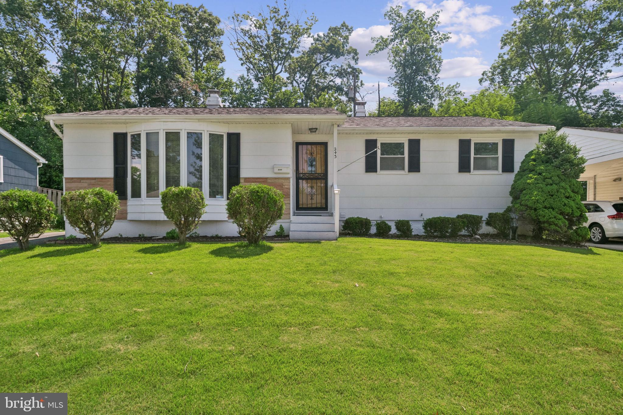Welcome to this beautifully refinished 3–4 bedroom, 3 full bath rancher, offering the perfect blend of comfort, space, and modern updates. Situated on a fenced back lot surrounded by mature trees for added privacy, this move-in-ready home features refinished hardwood floors, fresh paint, upgraded windows and doors, and ceiling fans throughout. The spacious living room is highlighted by a large bay window that fills the space with natural light, while the kitchen includes an abundance of cabinets and storage and opens seamlessly to the dining room. A sliding glass door off the dining area leads to one of large decks and the private backyard—perfect for outdoor entertaining. You'll love the sunroom addition for year-round relaxation, and the fully finished basement offers a huge open space complete with a full bathroom, second kitchen, and laundry room—ideal for guests, extended family, or additional living quarters. With driveway and street parking, an oversized storage shed, and a yard designed for both privacy and functionality, this home is truly a rare find and ready for immediate occupancy.