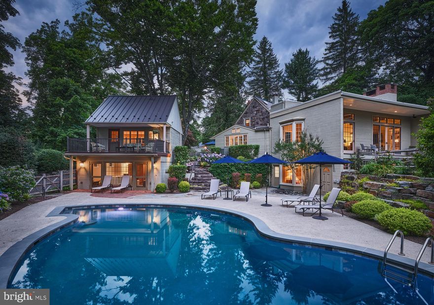 Just minutes from the center of New Hope, but with the  delightful  appeal of a rural retreat, this exquisite home, fully renovated and updated in 2019-2020, combines old stone barn charm and mid century elegance. Its lovely setting on one of Solebury's most picturesque roads offers privacy, beautiful outdoor spaces and stunning long distance views. Enter this gracious home into a large foyer with one of the old stone barn walls and striking herring-bone patterned brick floor. Adjacent is the expansive living and dining room, with soaring ceilings, wood beams and gleaming hardwood floors that run the full width of the fabulous mid-century addition. Here, walls of  sliding glass doors topped with transoms open on to a raised, covered porch that looks out to lawns and gardens and a spectacular pool with lush plantings. In the living room, a  wood-burning fireplace is flanked by elegant built-ins. The dining area is linked to the completely updated kitchen through a sleek butler's pantry with a wall of cupboards. The  kitchen features gorgeous quartz countertops, high-end stainless steel appliances, a ceramic farmhouse sink, generous custom cupboards and drawers and a comfortable peninsula with seating. Stone walls, brick floor, a wall of windows overlooking the pool, gardens and long distance views, along with a sliding glass door to the courtyard patio,  add to the fabulous ambiance of this exquisite space. Beyond the kitchen and back in the "antique" section of the house, is a serene family room/library graced by a stone fireplace and a large window looking out to a pretty enclosed garden. Completing the main level is a new tile powder room. Up a flight of stairs from the foyer is the home's light-filled main bedroom - a tranquil retreat with random-width wood floors, a decorative stone fireplace, an elegant, fully-renovated tile bathroom with glass shower, and double sinks. There are two additional, generously-sized bedrooms at the walk-out lower level, one with a charming window seat overlooking the pool and gardens. They share a new two-room tile  bathroom. The laundry is conveniently located here as well. Just beyond the beautiful courtyard patio and garden is the wonderful guest house which features a bedroom, living room/office, a full tile bath and a half bath. A large deck on the upper level, with its spectacular views, is the perfect location for morning coffee or sunset cocktails. The lower level of the cottage opens to the pool area. At the front of the property is  a generously-sized stone governor driveway with ample parking, and a three bay garage with storage. This unique and very special home is located only 5 miles from the center of vibrant New Hope, with its theater, art galleries, restaurants and music venues. The Holland Tunnel is a  69 mile drive; Philadelphia is 43 miles.