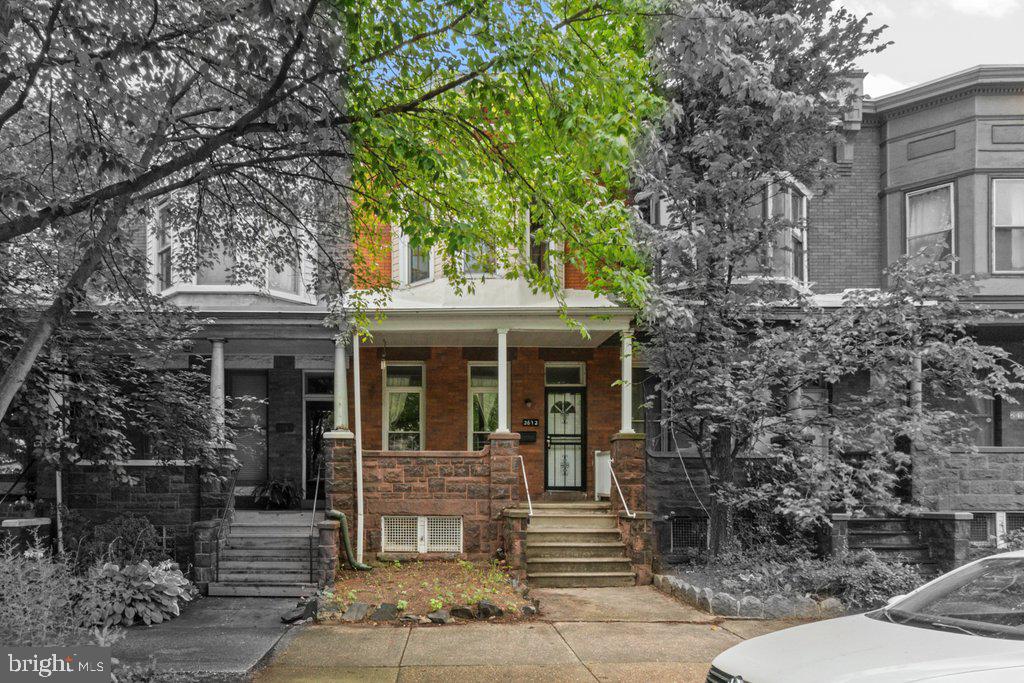 Welcome to 2612 Guilford Avenue, a spacious 5-bedroom, 1.5-bathroom home offering flexible living options in the heart of Charles Village.
The updated kitchen features granite countertops, wood shaker cabinets, a 30" electric range, built-in microwave, and a stainless steel double-door refrigerator with bottom freezer. Just off the kitchen is a powder room with ceramic tile flooring and a touch of exposed brick.
Exposed brick walls run throughout most rooms on both levels, adding character and warmth. The east-facing second-floor bedroom opens to a sunroom framed by glass-paneled interior windows—ideal for a reading nook, plant room, or a peaceful spot to enjoy coffee and a fresh treat from Motzi Bread, just 1.5 blocks north.
Don’t need five bedrooms? Use the first-floor front room, with its view of the porch and the iconic Painted Ladies across the street, as your home office, gym, or creative studio. A carved newel post on the stairway adds a decorative touch at the heart of the home.
The full, unfinished basement offers generous space for storage or recreational use and includes a laundry area. In the rear yard, a small, raised patio provides room to relax or entertain, and there's tandem off-street parking for two vehicles—an uncommon bonus in the neighborhood. The home also features vinyl replacement windows throughout for energy efficiency.
With a Walk Score of 93 and Bike Score of 81, this location puts you two blocks from Wyman Park and within easy reach of Johns Hopkins University, Starbucks, CVS Pharmacy, Chipolte, neighborhood cafés, and the 25th Street corridor. Toki Underground, one of the area’s newest hot spots, is just around the corner.