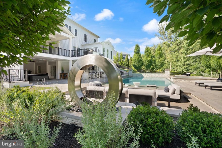 A breathtaking resort-caliber saltwater pool sets the tone for this extraordinary residence, delivering a true Ritz-Carlton–inspired experience in the comfort of your own backyard. Designed with a luxurious 7-foot depth and a premium soft-finish base, the pool invites both serene relaxation and elevated entertaining. A grand spa with cascading water feature and a striking designer ring fountain create a dramatic focal point, while evening uplighting transforms the entire setting into a private, five-star retreat.

Surrounding the pool, expansive custom hardscaping and a sleek track deck offer multiple spaces to lounge and gather—from elegant in-water loungers to a sunken conversation area centered around a modern fire feature. Dual fire bowls and a custom fire pit further enhance the ambiance, creating an atmosphere of warmth and sophistication reminiscent of the world’s finest resorts.

The outdoor living area continues seamlessly beneath the covered entertainment space, featuring a custom gas fireplace, a built-in natural gas grill, an outdoor refrigerator and ice maker, and all-weather TVs—perfectly designed for effortless hosting in every season. Thoughtful details, such as a Restoration Hardware umbrella and a premium outdoor fan, complete this refined outdoor environment.

Inside, the home carries forward the same elevated design with a brand new Luxury Vinyl floor, fresh designer paint, and upgraded lighting and fixtures throughout. A custom gas fireplace anchors the family room with modern elegance, while a desirable oversized main-level suite offers both flexibility and convenience for guests or multigenerational living. Custom craftsmanship is evident throughout, including coffered ceilings, a tray ceiling in the primary suite, detailed millwork, built-in office shelving, and a beautifully appointed butler’s pantry and mudroom.

Enhanced by a custom front entry, professionally designed landscaping, and a fully fenced yard, this home offers both striking curb appeal and peace of mind with updated major systems and appliances.

This is more than a home—it is a private retreat delivering a Ritz-Carlton lifestyle every day.

 This home sits in the award-winning Willowsford Community, surrounded by Loudoun’s wine country. Enjoy resort-style amenities—beach-entry pools, splash pad, lodge, fitness center, dog parks, sledding hill, tree house, and even a farm stand/CSA. Minutes from Brambleton and One Loudoun for dining, shopping, and entertainment, plus nearby Hanson Regional Park (257 acres!), farmers markets, Wegmans, wineries, and breweries. Convenient to Dulles Airport, Silver Line Metro, Tysons/DC, and top-rated Loudoun County schools.