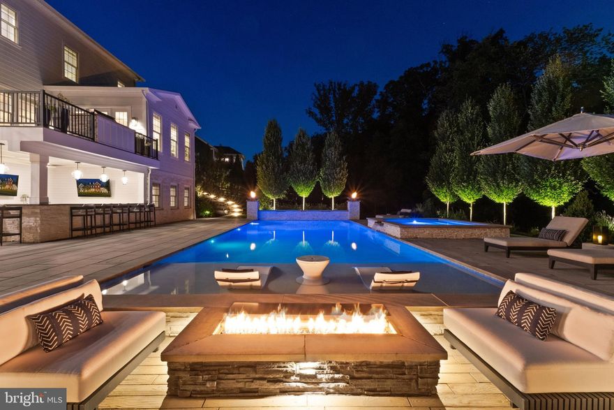 A breathtaking resort-caliber saltwater pool sets the tone for this extraordinary residence, delivering a true Ritz-Carlton–inspired experience in the comfort of your own backyard. Designed with a luxurious 7-foot depth and a premium soft-finish base, the pool invites both serene relaxation and elevated entertaining. A grand spa with cascading water feature and a striking designer ring fountain create a dramatic focal point, while evening uplighting transforms the entire setting into a private, five-star retreat.

Surrounding the pool, expansive custom hardscaping and a sleek track deck offer multiple spaces to lounge and gather—from elegant in-water loungers to a sunken conversation area centered around a modern fire feature. Dual fire bowls and a custom fire pit further enhance the ambiance, creating an atmosphere of warmth and sophistication reminiscent of the world’s finest resorts.

The outdoor living area continues seamlessly beneath the covered entertainment space, featuring a custom gas fireplace, a built-in natural gas grill, an outdoor refrigerator and ice maker, and all-weather TVs—perfectly designed for effortless hosting in every season. Thoughtful details, such as a Restoration Hardware umbrella and a premium outdoor fan, complete this refined outdoor environment.

Inside, the home carries forward the same elevated design with a brand new Luxury Vinyl floor, fresh designer paint, and upgraded lighting and fixtures throughout. A custom gas fireplace anchors the family room with modern elegance, while a desirable oversized main-level suite offers both flexibility and convenience for guests or multigenerational living. Custom craftsmanship is evident throughout, including coffered ceilings, a tray ceiling in the primary suite, detailed millwork, built-in office shelving, and a beautifully appointed butler’s pantry and mudroom.

Enhanced by a custom front entry, professionally designed landscaping, and a fully fenced yard, this home offers both striking curb appeal and peace of mind with updated major systems and appliances.

This is more than a home—it is a private retreat delivering a Ritz-Carlton lifestyle every day.

 This home sits in the award-winning Willowsford Community, surrounded by Loudoun’s wine country. Enjoy resort-style amenities—beach-entry pools, splash pad, lodge, fitness center, dog parks, sledding hill, tree house, and even a farm stand/CSA. Minutes from Brambleton and One Loudoun for dining, shopping, and entertainment, plus nearby Hanson Regional Park (257 acres!), farmers markets, Wegmans, wineries, and breweries. Convenient to Dulles Airport, Silver Line Metro, Tysons/DC, and top-rated Loudoun County schools.
