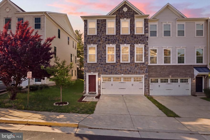 Don’t miss this stunning stone-front Craftsman-style end-unit townhome offering 3 finished levels, 4 bedrooms, and 3.5 baths! Just 5 years young and gently lived in, this home is loaded with upgrades and perfectly situated on a premium lot on a quiet no-thru street backing to trees.

The main level features an open-concept layout ideal for modern living and entertaining, highlighted by a spacious family room with a gas fireplace that opens to a composite deck overlooking private wooded views. Enjoy hardwood flooring throughout, a massive kitchen island, granite countertops, rich espresso cabinetry with soft-close doors and pull-out storage, stainless steel appliances, a walk-in pantry, double wall oven, and ample dining space.

Upstairs, the luxurious primary suite offers a sitting room, walk-in closet, and spa-like bath with dual vanities, soaking tub, and seamless glass shower. Two additional generously sized bedrooms, a full bath with dual sinks, and a large laundry room with extra shelving and upgraded cabinetry complete the upper level.

The fully finished walk-out lower level includes a spacious recreation room, a 4th bedroom with walk-in closet, and a full bath—perfect for guests or extended living.

Conveniently located less than 2 miles from the Ashburn Metro Station and close to shopping, dining, and major commuting routes.