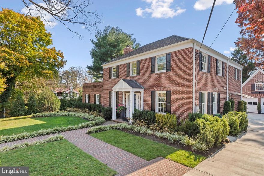 Wrapped in brick and framed with beautiful landscaping, this Chevy Chase View colonial has been masterfully renovated to offer modern living within a framework of classic architectural style.  Every detail was considered in the 2020 renovation, which opened up the floor plan with wide cased moldings, expansive new windows, granite and quartz surfaces, a fabulous new kitchen and refinished hardwood floors.  The primary rooms include an inviting dining room that leads to a chef’s dream kitchen with a substantial quartz island, Viking and Bosch appliances and custom soft-close cabinets and drawers.  Perfect for today’s busy household, there is a stackable washer/dryer in the kitchen space.  The kitchen adjoins an expansive casual dining area and family room that is saturated in natural light and enhanced by mesmerizing views of the grounds.  A handsome living room is steps from the family room area and features a wood burning fireplace appointed with black granite.  Dual doors from the living room open to a private home office and a sunroom with an exposed brick wall, two Restoration Hardware ceiling fans, and fabulous views.  With its open, circular floor plan, this home is every entertainer’s dream.  The sunroom and family room both open to a beautiful brick terrace with custom light fixtures that create a magical setting for outdoor gatherings.  
Upstairs, there are 3 bedrooms and 2 full baths.  The luxurious primary suite features large window expanses, two California Closet-designed closets, and a stunning bath appointed with custom Porcelanosa tile.  The other two bedrooms share a renovated full bath and both have ample space for furnishings.  One of the bedrooms opens to an upper level deck; and both have their own character and style.  
The lower level is ideal for the household or guests, complete with built-in furnishings, a large living/bedroom space and a new full bath.  An adjoining unfinished area offers a large storage space and lower-level laundry room.  
Step outside to the private backyard and enjoy the lush landscaping and level lawn area that is framed with trees.  At the end of the driveway, a detached three-story garage is full of opportunities to finish to your own liking.  There is space for two cars and a light and sunny attic level that could be a studio, a child’s playroom or a teen hangout.  The lower level is ideal for finishing as a private guest house.  The lower level has electricity and water, and has the perfect square footage for a bath, kitchenette and living/sleeping space.  Just bring your own design dreams! 
This home offers the perfect canvas for art, with natural light and neutral colors setting a tone of understated elegance, with the outdoor living space adding a beautiful, natural compliment.   Moments from downtown Kensington’s dining and shopping, the Marc Train into the city, and the biking and walking trails that lead into Rock Creek Park, this residence has every amenity for an active lifestyle.  It is close to excellent public and private schools and commuting routes to every corner of the DMV.  A truly stunning property, this is the essence of fine living.
