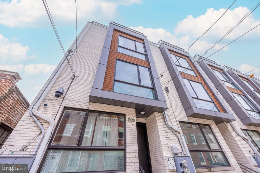 Read to the end for more info on how to save big on financing for this home! Don't miss the opportunity to get into a gorgeous home in the rapidly developing and quickly appreciating Francisville neighborhood. With close proximity to many local amenities and affordable prices for luxury living, this is city living at its finest! This spacious high-end luxurious bi-level unit is not your cookie cutter renovation. Occupying the 2nd and 3rd floors of a new construction townhome, you will find three bedrooms, three bathrooms, balcony and rooftop deck, with high-end contemporary finishes and smart home technology throughout. Upon entering, ascend a wide staircase to the bright and sunny open concept  main living level where soaring 11-foot ceilings and floor to ceiling windows offer a light and spacious atmosphere. The kitchen is a chef's dream with its stunning, extra long quartz waterfall countertop, JennAir appliances and massive walk-in pantry. The adjacent living room opens onto a balcony with skyline views, perfect for dining al fresco.  This level also offers a large front bedroom or office and full bathroom. Ascend the stunning glass staircase to the upper level where a spacious hall and landing opens onto the spectacular master suite, also with city skyline views. The massive en-suite bathroom with floor to ceiling tile, glass-enclosed soaking tub, radiant heated floors and towel warming rack, create a truly luxurious spa-like experience an comes complete with huge walk-in closet. Another full bedroom and full bath occupy this floor along with a conveniently located laundry room with full-sized laundry, ample storage space and sink. A wet bar with a wine fridge and storage space make hosting a breeze on your way to enjoy the unobstructed city views on your spacious rooftop deck. Roof was just replaced in 2024 and is under warranty. Enjoy city living at its finest along with access to nearby public transit, shops and restaurants, as well as 4+ years left on the tax abatement! This home is also eligible for additional savings through the NeighborFirst program, which can save eligible buyers an entire point on their mortgage, with no PMI and as little as 3% down. No income limits to qualify and if buyer is a first time buyer, they may be eligible for a $6k closing cost credit!