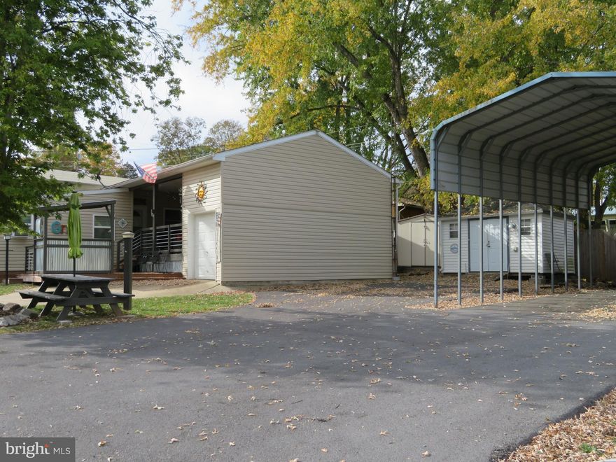 HUGE PRICE REDUCTION!!  CALL TODAY TO MAKE YOURS!!  Own this seasonal summer vacation getaway in as little as 3 short weeks!!     Bring your family, pets and friends!! This vacation getaway has plenty of room!! Property comes with 2 lots & 1 RV. Lot 12 has a well maintained 2009 Jayco camper.  This fully furnished RV features a king bed in the master, lots of storage, kitchen, dining area and a stereo system. In addition to the RV, the lot features an 11X12 furnished family room, a 13X16 bonus room (possible bedroom), 12X19 covered deck, 24X8 golf cart garage with electric and a loft area for storage, 8X8 shed, fire pit, fenced pet area and paved driveway. NEED MORE ROOM??   Lot 13 has a 10X12 shed with electric, parking and a pavilion waiting for an additional RV. Yearly membership includes water, pump out, electric, trash and the park amenities such as pools, putt putt, basketball, tennis, fireworks, car show, carnival, restaurant, playground, ball field and much more.  SELLER WILL ENTERTAIN ALL REASONABLE OFFERS!!