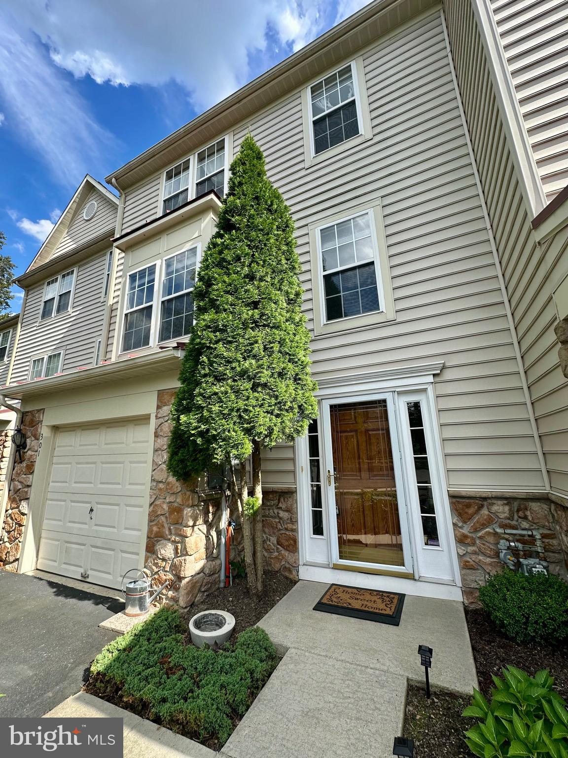 Welcome to 301 Devon Court. This three story, 2006 built townhome is located so close to 202/309 access yet tucked back in at quiet cul de sac. Both the lower level paver patio and the second level maintenance free deck offer a peaceful, wooded view.
Do you like hardwood flooring? The foyer, three bedrooms, hallways, steps and entire second level's gorgeous hardwood flooring are ready to compliment any style of decor.
The first floor garage entry or front door entrance lead to a foyer area. This first level is home to an enormous family room with a gas fireplace, powder room, coat and storage closets as well as the laundry room and separateHVAC closet. Up the staircase to level two you'll find an open concept kitchen, family room, dining space, sitting area with gas fireplace #2 and sliders to the wrap around deck. The current homeowner is open to including the deck furniture and grill.
The third level master bedroom has vaulted ceilings and an impressive walk in closet. The double vanity, soaking tub and walk in shower complete the master suite. Both of the the additional bedrooms are nicely sized and share a hall bathroom.
The HOA fee takes care of your lawn care, snow removal, trash and common area maintenance. The HOA also takes care of exterior maintenance. The roof is just about brand new with a 2024 installation and warranty!