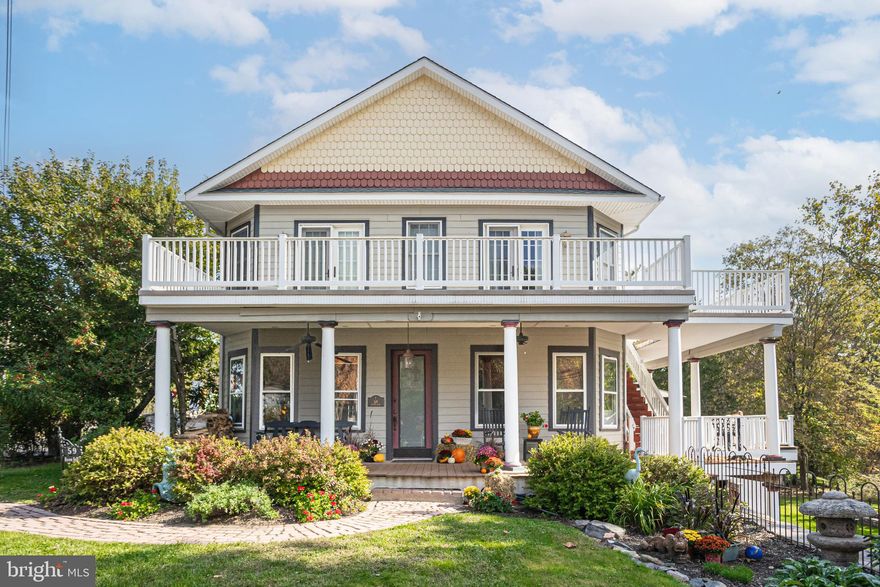 Set in the very heart of Point Pleasant, an historic Bucks County river town going through a revitalization, this gorgeous 1900’s Victorian has a gracious flowing floorplan and has been beautifully preserved and updated throughout. An incredible multi-level wrap-around front porch offers prime views of the Tohickon Creek, the charming hamlet, and the Point Pleasant Bridge featuring art by local artists. The original glass-paned front door opens into an expansive living room with a fireplace with wood-burning stove insert, abundant windows, exposed beams, high ceilings, and wood floors. Arched pocket doors open into the bright dining room with French doors that lead out to the expansive maintenance free deck overlooking the shady yard and creek beyond. The spacious eat-in kitchen is warm and welcoming with stainless steel Wolfe and Subzero appliances including double ovens and gas stove with griddle, granite counters, large center island with prep sink, ample storage with walk-in pantry, and adjacent powder room. Upstairs, the primary bedroom suite is an incredible private retreat with a massive walk-in closet, and French doors that open to the second story wraparound porch where you can enjoy sightings of bald eagles and red-tailed hawks as you sip your morning coffee. The huge ensuite bathroom has a claw-foot soaking tub and tiled shower. Two more lovely bedrooms with great natural light share a full hall bathroom, and a second floor laundry room adds convenience. A partially finished walk-out basement offers additional space, a full bathroom, plus direct access to the huge attached garage with abundant room for parking, storage, and workshop. Sitting on over a 1/2 acre, enjoy a shady yard with fire pit and shed, while being just steps to eateries, shops, amenities, and the Delaware River and canal towpath.
