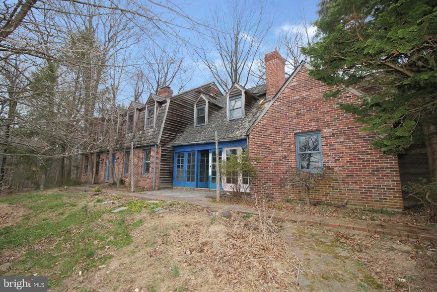 Country estate on over 12 acres ready to be rehabbed and brought back to its former beauty. This house offers good bones and design that is not available in new construction. With multiple living and dining areas, 4 bedrooms, 3.5 baths, the design options are endless. There are three fireplaces with one being in the primary suite.  Architectural features such as wood-beamed ceilings, wood floors, chair rails and crown molding bring elegance to the spaces. Floorplan is designed for comfortable living and easy entertaining with spacious rooms that flow together. 

Enjoy the outdoors on the large, multi-level deck with views of the surroundings. A full unfinished basement provides additional flexibility for more living space and storage.

Book your showing today to see first hand all the potential that awaits. This estate can again become a harmonious blend of luxury, comfort and functionality to provide an idyllic retreat for those seeking a lifestyle of refined living amidst nature's beauty.
7-day marketing period. Any/all offers to be uploaded to the bank on Day 8.