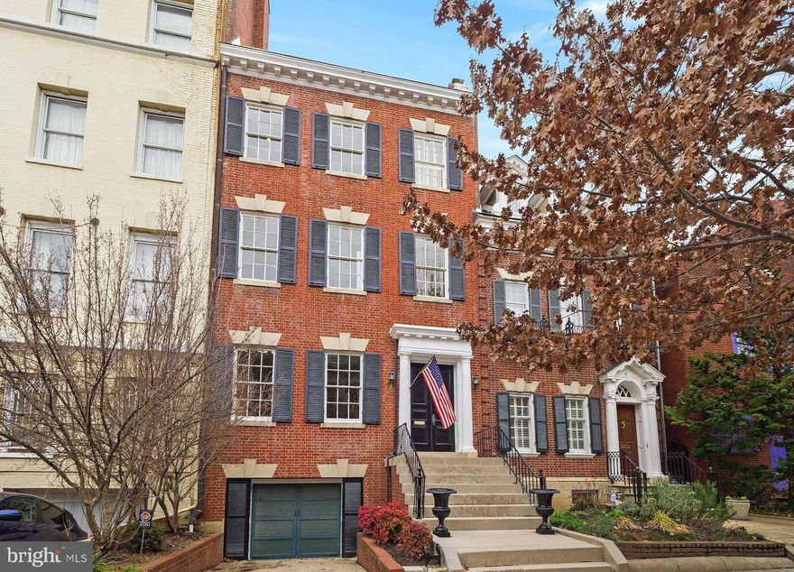 With its soaring ceilings, southern exposure, and original details, 2137 R Street NW invites you to explore its well-appointed interiors and private outdoor spaces.  Spanning four floors, this stately, five bedroom home includes five fireplaces, a home office, two outdoor spaces, and a heated garage. The main level is an entertainer’s dream, with fireplaces in both the living and dining rooms, a second sitting area, an eat-in kitchen with a butler’s pantry/bar, a powder room, all opening to a large patio. The second level can be configured as a main suite and boasts two fireplaces, a large dressing room, a separate sitting room, one and a half baths, wet bar, and large, private deck.  The top floor has three bedrooms, one with a fireplace and en-suite bath, one additional shared bath and the home office. The lower level one bedroom suite includes a private entrance, kitchenette, and its own laundry.