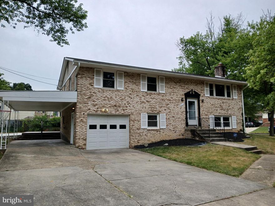 All brick Single Family home featuring 4 bedrooms and 3 full bathrooms.  Beautiful hardwood floors on upper level. New luxury vinyl Flooring on lower level.  Recessed lighting.  1 car garage and car port for plenty of off street parking.  Large Yard, concrete patio.  A must see, Buyers won't be disappointed.  No HOA.  Call helpful agent with questions.