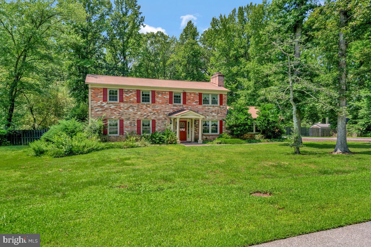 Welcome to this charming 4-bedroom 2.5 bath Colonial nestled on a peaceful, wooded lot in sought-after Lorton! This well-maintained brick-front home offers timeless curb appeal and generous interior living space. Inside, you'll find hardwood and tile flooring throughout, a spacious living room, formal dining room, and a cozy family room with a stunning brick fireplace. The bright kitchen features granite countertops, white cabinetry, and a breakfast area with direct access to the backyard. The expansive primary suite offers great natural light and a second fireplace for added comfort. Recent upgrades include a new gas furnace for year-round efficiency. Step outside to your private backyard retreat—featuring a large deck and heated in-ground pool with a new filter system—perfect for entertaining or relaxing in nature. Additional highlights include a 2-car garage, spacious entry foyer, and abundant storage throughout. All set in a quiet, established neighborhood just minutes from parks, shopping, and commuter routes.