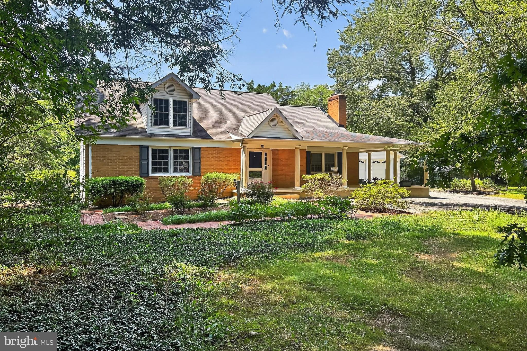 Truly a must see. No cookie-cutter here unless you're baking something in the gourmet kitchen. This custom built home has been painstakingly maintained and gorgeously renovated by the current Owner with hardwood flooring, travertine, porcelain tile, high grade fixtures, crown molding, wainscoting and so much more. An extensive renovation over the years to include, roof, windows, kitchen, baths, a 2 car garage, all using premium materials and fixtures making this wonderful brick Transitional/Cape highly desirable. Situated on a 2 plus acre homesite overlooking trees and a private pond, offering peace and serenity. The home perfectly balances modern living with timeless charm. It features 5 spacious bedrooms and 3.5 beautifully designed bathrooms, making it ideal for families of any size. The floorpan offers easy flow for entertaining and is filled with natural light. The gourmet Kitchen showcases elegant porcelain tile floors with granite accents, stainless appliances, two stoves, stainless appliances: a Chef's dream. A large Primary Suite with private bath, and sitting area offers easy main level living. A fabulous four season room on the rear features sliding windows to let the scent of nature flow freely throughout. Step outside to find a newly completed patio and stairs leading down to the large lawn. Carefree living is perfect here, where you can cast a fishing line into the pond for bass or blue gill, or sip your coffee and read a book on the large wraparound porch out front. The perfect home for low key family affairs or for entertaining guests. With Route 66 , I-95 and the VRE just down the road, commuting choices abound. Don’t miss the opportunity to make this your dream home!
