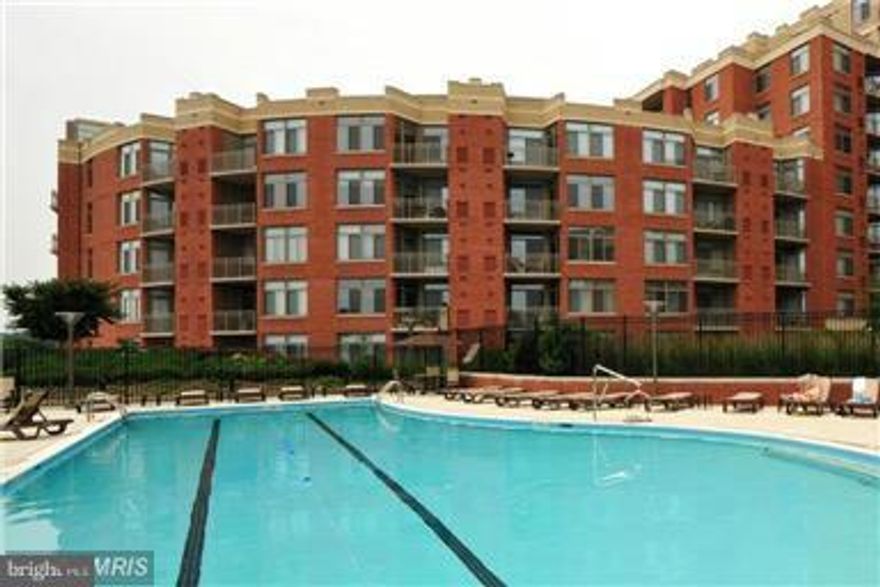 YOUR CHANCE TO PURCHASE THIS AMAZING CONDO AT GREAT PRICE! BACK ON THE MARKET NOW!Great floor plan, 2 car garage spc, storage unit, Hardwood floor, Upgrades,Gourmet kitchen w/granite counters, SS appliances, ceramic tile, new refrigerator,ceiling fan &lights in BR, TV & Fireplace conveys. Great amenities incl. Pool, fitness,Harris Teeter supermarket 24/7.