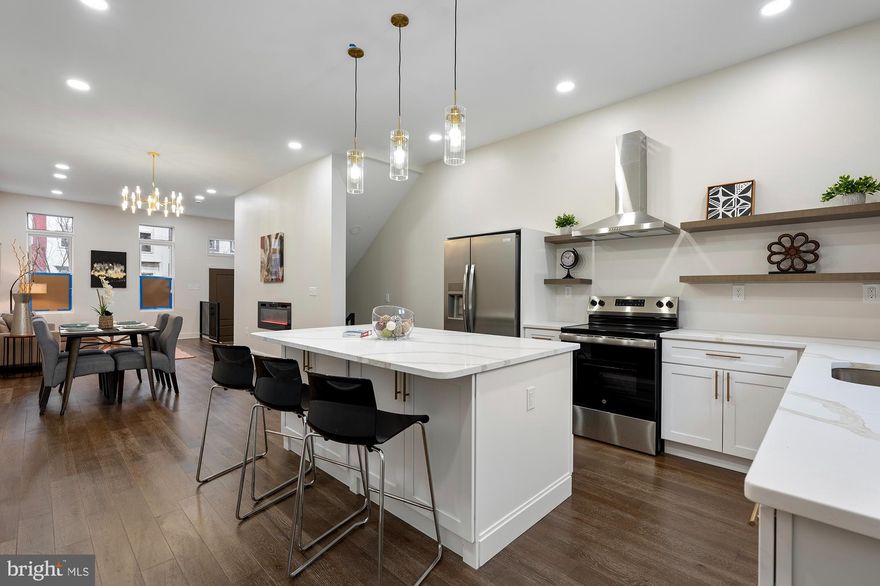 Welcome to this stunning 16ft-wide fully renovated home, offering modern elegance and thoughtful design. Step inside to find wood flooring throughout, creating a warm and inviting ambiance. The spacious living room flows seamlessly into the dining area, featuring a cozy electric fireplace, perfect for gatherings. The island kitchen is a chef’s dream, boasting stainless steel appliances, Quartz counters, and ample cabinetry.  The second level offers two generously sized bedrooms and a luxurious full bath with a large walk-in shower and dual showerheads. The third level features two additional bedrooms and a well-appointed hall bath, providing ample space for family or guests.  The fully finished basement includes a versatile family room, an additional bedroom, and a full bath, ideal for hosting visitors or creating a private retreat. Outside, enjoy a private rear yard, perfect for entertaining or relaxation.  Located on a street undergoing exciting transformations with numerous renovations, this home is a perfect blend of contemporary style and vibrant community living. Eligible for 10k Vacants to Value grant and 20k in closing cost assistance through the Southwest Partnership!  Don’t miss this incredible opportunity!