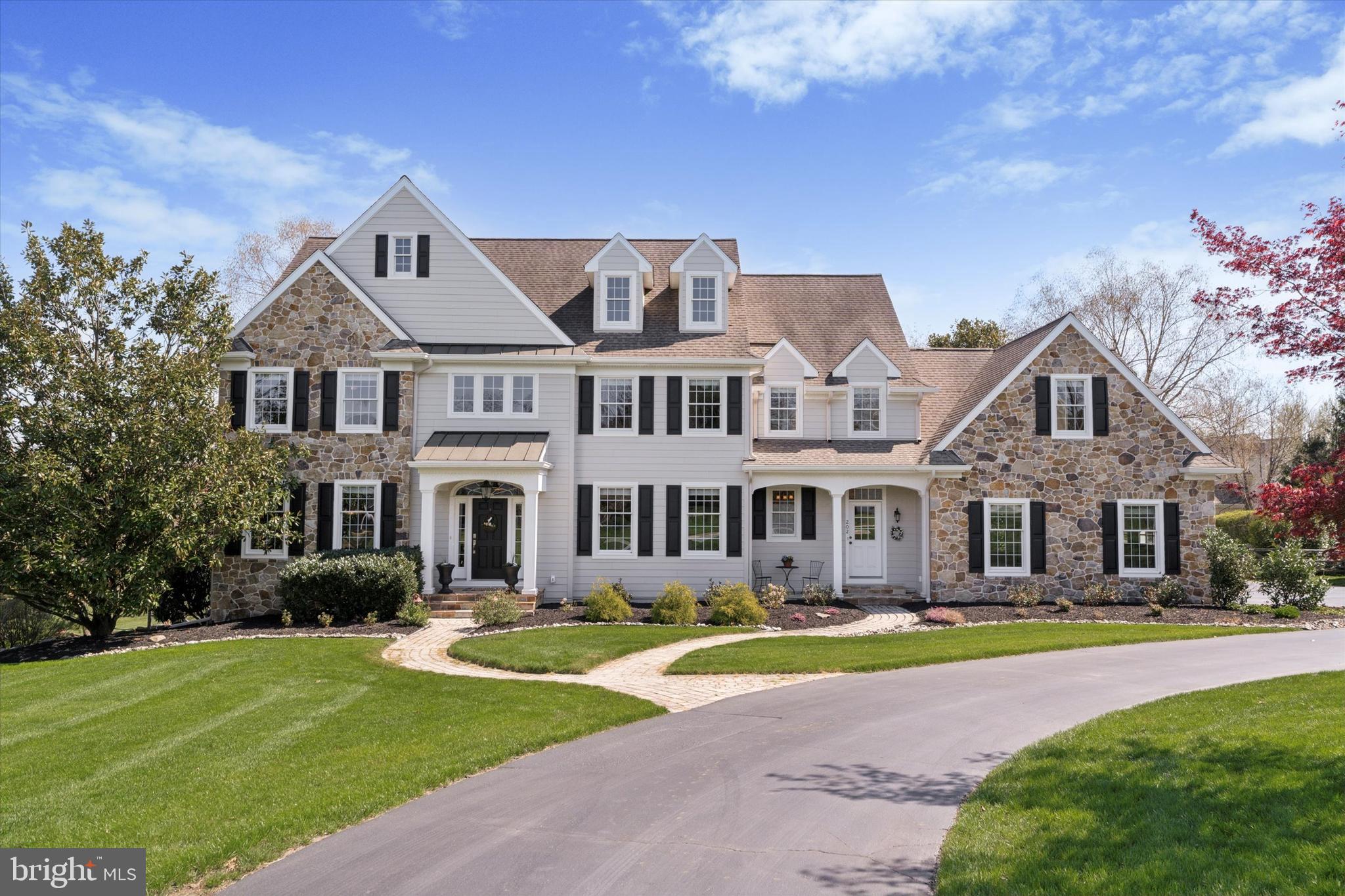 Nestled in the heart of the prestigious Newlin Greene community, this custom-built home offers over 7,000 square feet of thoughtfully designed living space. From its elegant interior finishes to the private backyard oasis with a pool and spa, every inch of this residence is tailored for both everyday comfort and exceptional entertaining.
As you step through the front door, you're welcomed by a gracious entryway, flanked by the formal dining room to your right and the formal living room to your left. Straight ahead, the home opens up into the heart of the residence — a gourmet kitchen that flows effortlessly into the sunny breakfast nook and family room with a stunning fireplace.
The kitchen is a chef’s dream, featuring a large center island, walk-in pantry, dry bar, and coffee bar. Thoughtfully designed with high-end finishes, premium appliances, plenty of storage, and two sinks for maximum function and style. The breakfast nook opens to a flagstone patio that overlooks the private open space, pool, and spa — offering panoramic views of the countryside.
Elegant details such as wainscoting and custom trim work accentuate the formal living and dining areas. A private study, two main-level powder rooms, and an oversized laundry/mudroom with a shower (perfect for pool days) add to the thoughtful layout. A second fireplace warms the front family room, and dual staircases—one off the foyer and one off the kitchen—offer convenience and flow throughout the home.
Upstairs, the luxurious primary suite boasts a spa-like bath and custom walk-in closets. You'll also find four additional spacious bedrooms, each with great closet space, including a Jack-and-Jill suite, a third hall bath, and a flexible fifth bedroom ideal as a playroom or bonus space. A walk-up attic leads to an unfinished third level, perfect for future expansion or storage.
The finished basement is an entertainer’s paradise with walk-out access, a private gym, work area, second laundry area, full bath, and gas fireplace.
Additional highlights include a three-car garage with built-in cabinetry, whole-house surround sound (including the lower level, patio, and pool area), a whole-house generator, and beautifully manicured landscaping and hardscaping. The property backs to protected HOA-maintained open space that cannot be developed, offering lasting privacy and scenic views.
Located on a premium lot in the award-winning Unionville-Chadds Ford School District, this exceptional home offers the best of luxury living in a peaceful, well-maintained community. Schedule a private showing today!