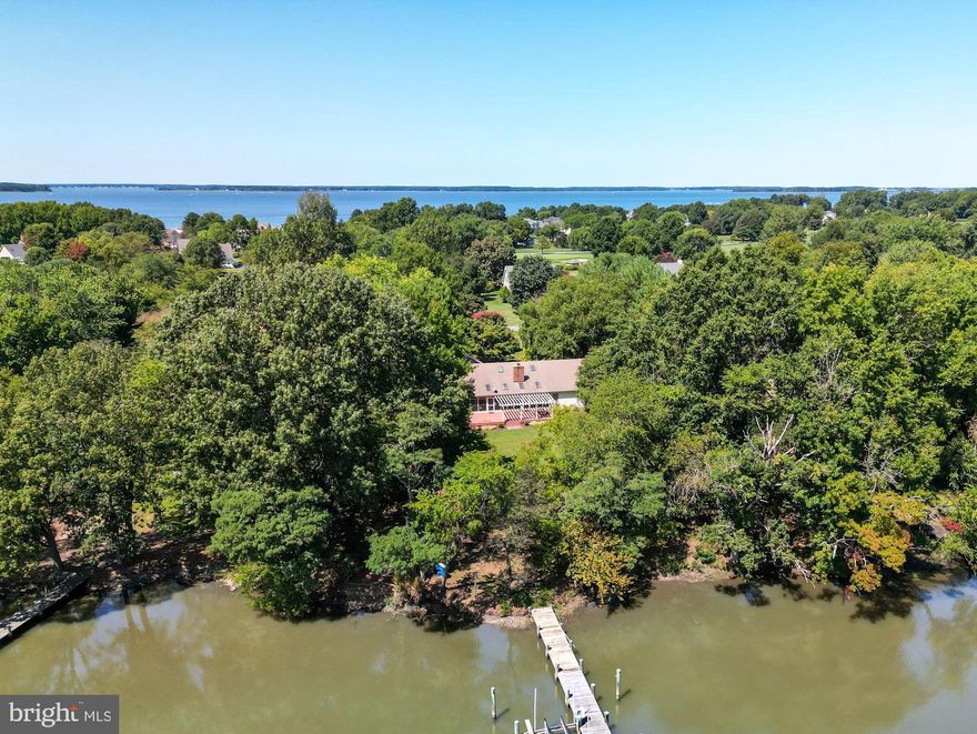 Discover the charm of Prospect Bay with this thoughtfully designed, single-level living home with breathtaking panoramic water views. Perfect for relaxation or entertaining, the open floor plan seamlessly integrates into an expansive outdoor living space. Enter the home and be greeted by the Family Room, featuring vaulted ceilings, a stone fireplace, skylights, and oversized windows framing your view of Greenwood Creek. 

The open concept kitchen and living spaces are designed for both functionality and style, featuring cherry cabinetry, butler’s pantry, ample counter space, an island with seating, a sink, and wine & glass racks. Adjacent to the kitchen, you'll find a cozy dining area that opens onto a spacious waterside deck.

This home includes four generously sized bedrooms, with the primary bedroom enjoying water views and direct access to the screened in porch. Primary bathroom features a soaking tub, shower, water closet, double sinks, and an impressive walk-in closet. Additionally, there’s a convenient laundry / mud room off the kitchen and a two-car garage for all of your vehicle and storage needs.

The property offers wrap-around water frontage, a pier with approximately 3' MLW (buyer to verify), and sits on just over one acre in the desirable Prospect Bay Golf & Country Club community.

Prospect Bay offers resort-style amenities year-round, including an 18-hole PGA golf course, tennis, pickleball, pool, restaurant, playground, private beach, and marina. Conveniently located a short drive from the Chesapeake Bay Bridge, Annapolis, Easton, and the beach, this extraordinary waterfront property presents a rare opportunity to live in Prospect Bay and enjoy the best of Eastern Shore living. Welcome home!