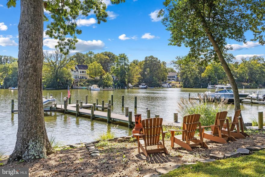 A rare waterfront haven where timeless craftsmanship meets effortless coastal living. Tucked into almost an acre in Amberley, this custom home was completed in 2018 on one of Annapolis’ most desirable deep-water creeks. A private pier with 9'MLW, and a 15,000 lb lift provides quick access to the Chesapeake Bay—an ideal setup for serious boaters and sunset cruisers alike.

Inside, every detail reflects thoughtful design. The hand-crafted Douglas Fir entry door opens to soaring, light-filled spaces where walls of glass capture sweeping water views. The open plan is perfect for gatherings, whether around the fireplace beneath a reclaimed cedar ceiling or on the waterside deck overlooking the creek; perfect for grilling or relaxing. The gourmet kitchen anchors the heart of the home with a massive island, custom cabinetry, and top-tier appliances.

With four bedrooms, including a luxurious main-level suite and a second waterside suite upstairs, the home is equally suited for everyday comfort and weekend entertaining. The lower level adds versatility with space for a fitness studio, game room, or even a theater, all enhanced by water views.

A three-car detached garage and thoughtfully designed, lush landscaping complete the property. The Amberley neighborhood boasts 3 community piers on Whitehall and Ridout creeks with easy access to the Chesapeake Bay, Annapolis, and the Bay Bridge, you can enjoy boating and fishing on the Bay, as well as walking, jogging, and bike riding along the scenic roads and trails which meander through the neighborhood. Located in the award-winning Broadneck school district and with easy access to RT 50, Annapolis, shops and restaurants. Welcome Home!
