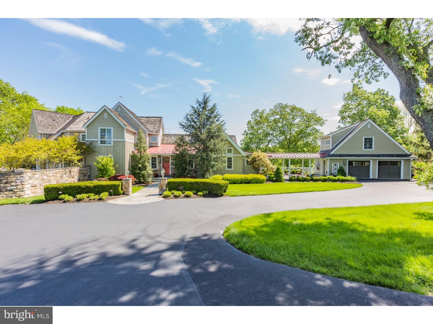 Spectacular architect designed home is perched above the road in a sensational display of stone and natural materials and graced with lush mature landscape. Inspired by its beautiful setting, walls of windows showcase verdant vistas above the tree tops and bring the outside in. Displays of form meeting function are exquisitely executed throughout. Wide board cypress floors, soaring ceilings, exposed beams and iron ties speak to a refined rustic beauty and create the ambiance of an elegant converted barn. Its floor plan offers the perfect balance of intimate spaces and grand open areas that are ideal for entertaining as well as daily life. The heart of the home is a wall-less space of its kitchen with an ideal work triangle and professional appliances, dining and living room areas separated by a two sided stone fireplace and a raised family room. The master suite is a study in serenity with its bedroom chamber bathed in diffused light and offering a luxurious private bath with radiant heat floor, sitting room, dressing room and large walk in closet. Secondary bedrooms are all well proportioned and contain generous closet space. A stylish finished walk out daylight basement with polished concrete floors features three large rooms well suited for a home gym, game room with wet bar, office, craft area and has one full bath as well as a powder room and second laundry room. The exterior offers both a delightful porch, stone veranda and sensational pool with sheer waterfalls, fully equipped outdoor kitchen and a gazebo style cabana with living area, fireplace and flat screen TV. A charming guest suite (not included in bedroom/bathroom count) sits atop the carriage house style garage. Reaffirming the impression that the residence is of historic vintage, an early stone spring house sits alongside a winding creek. This rare gem is unlike any other and is sure to offer warm welcome and beckon Home Sweet Home.
