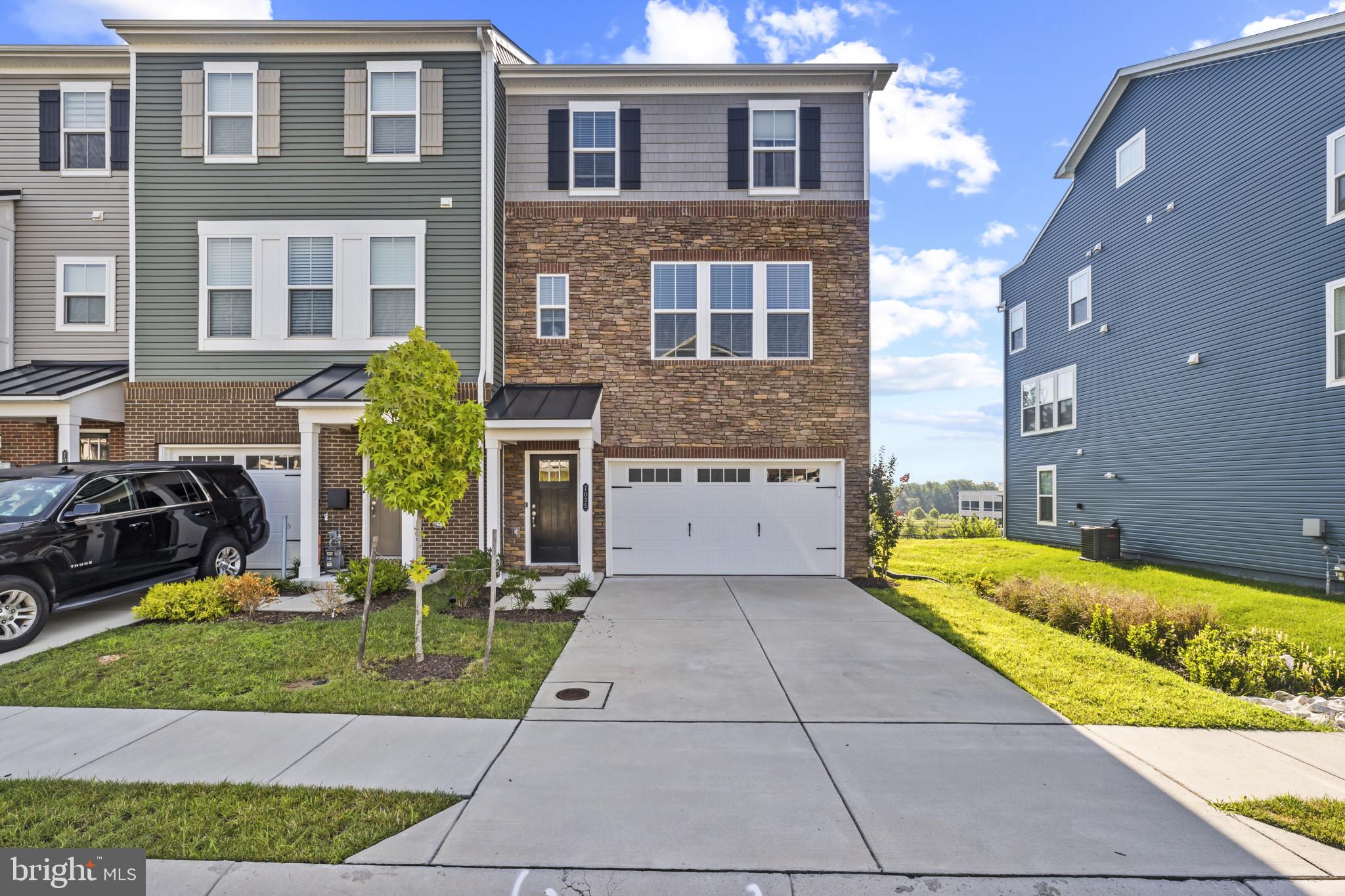 Stunning End-of-Group Townhome – Move-In Ready! Why wait for new construction when this nearly new, upgraded beauty is ready now!! The stone front and oversized garage create an impressive first impression. Featuring 3 spacious bedrooms, 2 full and 2 half baths. Drenched in natural light, this home shines with gleaming LVP floors, a chef’s kitchen with stainless steel appliances and upgraded cabinets, plus an oversized 1-car garage. The kitchen island flows seamlessly to a deck overlooking serene wooded views—perfect for relaxing or entertaining! The spacious primary suite features a walk-in closet, ensuite bath with double vanity, and a large frameless glass shower. Convenient upstairs laundry is located near all bedrooms. The lower level offers a versatile rec room, garage access, and a half bath, with a walk-out to a backyard that provides plenty of play space. Perfectly located near shopping, dining, and commuter routes, this is the stylish, low-maintenance lifestyle you’ve been waiting for!