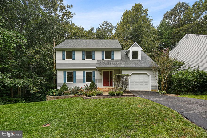 This 4-bedroom, 2 and a half bath home is truly a gem, with its extensive updates and beautiful features. The covered front entry welcomes you into a hallway adorned with gleaming hardwood floors that continue throughout the main level, adding a touch of elegance. The gourmet kitchen is a standout feature with granite counters, stainless steel appliances, a center island, electric cooking, recessed lighting, and stylish shaker-style cabinets, making it a delightful space for culinary enthusiasts. The living room, adjacent to the kitchen, offers comfort with a carpeted floor, skylights, a brick-surround wood-burning fireplace, and sliders to the deck, providing a perfect setting for morning coffee and relaxation. The dining room, opening to the family room, boasts crown molding and recessed lighting, creating an inviting atmosphere for family gatherings and meals. A convenient half bath completes this level. Upstairs, you'll find newly carpeted floors throughout, providing a cozy and comfortable ambiance. The primary bedroom is a true retreat, featuring a ceiling fan, a large custom walk-in closet, and a primary bath with a separate shower and a single vanity for added convenience and luxury. Additionally, there are three more bedrooms on this level, each with ample closet space to accommodate the needs of a growing family. A full bath with a jetted tub and tile flooring adds functionality and style to this level. The lower level houses a spacious basement with a huge, unfinished storage area, offering ample space for organizing belongings and future customization. There's also a laundry room, adding practicality to everyday living. The home boasts a long driveway and a one-car garage, providing ample parking and storage options. The front yard is beautifully landscaped, enhancing the curb appeal and adding to the overall charm of the property. This move-in-ready home is a perfect blend of modern updates and timeless charm, making it a must-see for anyone in search of a comfortable, stylish, and functional residence.