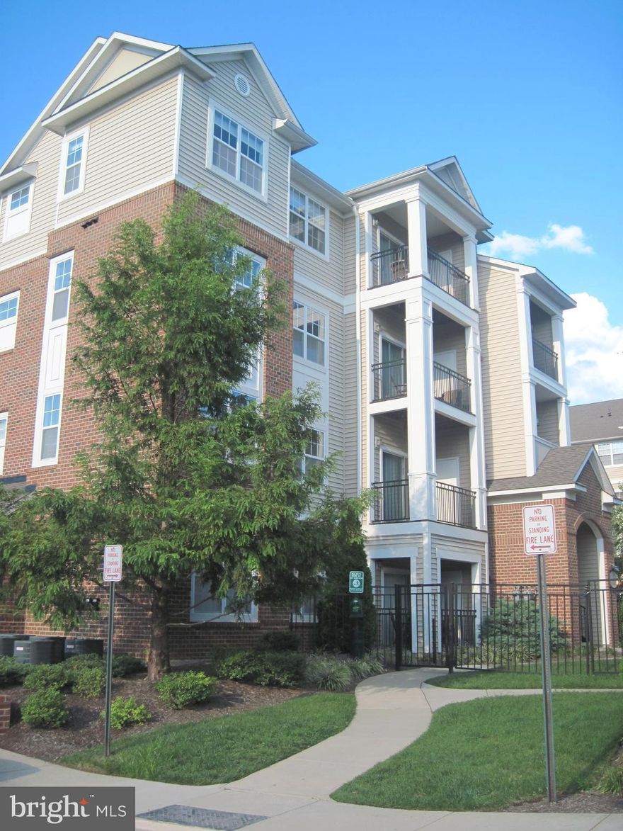 Shows like a MODEL>Modern & spacious, largest 2BR + 2BA in luxurious Bryson>Gourmet kitch. w/granite counters & SS appliances>Impressive gas fireplace>Big bedrooms w/walk-in closets>Full size W/D>Balcony>2 GARAGE spaces>Gated community with:2pools; Game Room; Modern fitness center; hot tub; club house; BBQ area; Bus.Center>Park & Ride to DC 1blk>Walk to Grocery, shops, restaurants>Close to Dulles