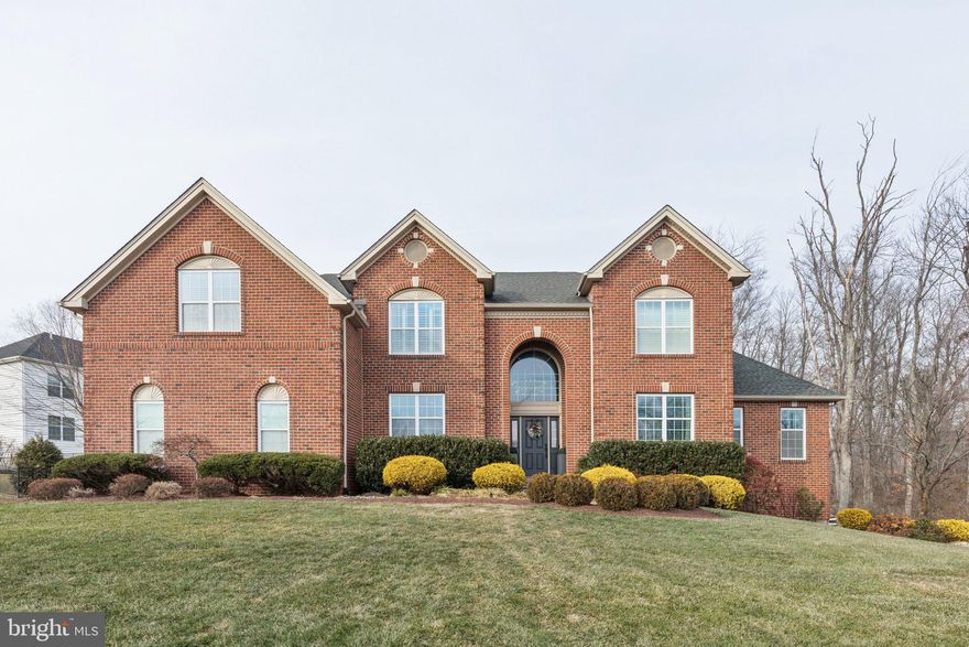 Welcome to 2801 Hoffs Way! Enter the foyer to find hardwood floors, high ceilings, and abundant natural light. To the left is a home office with built-in bookshelves, adjacent to a main floor powder room. Further in, a large coat closet and a mudroom with extensive cabinetry, a utility sink, and a bench providing storage and organization.

The chef’s kitchen is filled with light and features an oversized sink, stainless steel appliances including a Wolf 6-burner range and double ovens, quartz countertops, a large island with storage and seating for four, and abundant cabinetry. A nearby pantry with pull-out shelving adds even more storage. The eat-in dining area connects directly to the kitchen and provides access to the patio. The three-car garage is also accessible from this space.

The formal dining room and living room sit on either side of the kitchen. The dining room features wainscoting and ample space for hosting, while the living room offers crown molding, a built-in entertainment space, and a gas fireplace. To the right of the front door, the formal sitting room flows into the vaulted-ceiling great room, currently used as a playroom, creating a bright and versatile space.

Upstairs, five bedrooms and three full bathrooms provide privacy and comfort. The primary suite is a luxurious retreat with a sitting area, electric fireplace, and a walk-in closet. The en-suite bath offers a soaking tub, standing shower, double vanities, extensive storage, and a separate toilet room. A massive second walk-in dressing closet features custom hanging and shelving. The second bedroom includes a walk-in closet and oversized windows, while the third bedroom has direct access to a full hall bath with double vanity. Two additional bedrooms share a Jack-and-Jill bath with double vanity, tub-shower combo, and a linen closet. A separate laundry room with storage completes this level.

The finished basement provides extensive entertainment space with a pool table, dart board, wet bar with quartz countertops, and built-in storage. A full bath and a small dining area are also included, plus original pub windows from England dating to the 1800s. A guest bedroom with built-in desk and a large storage closet with built-in bins are also in the basement, alongside a cozy music nook. Bilco doors lead to the backyard from this level.

Outside, the long driveway leads to a three-car garage with extra depth for large vehicles, built-in bike rack, and cabinetry. The backyard offers a pergola-covered entertaining area with a built-in gas grill, seating for dining, and privacy backed by preserved woods.

This home is in a prime Warrington location near Valley Square, Warrington Crossing, and Peace Valley Park, with Lake Galena nearby and easy access to major commuter routes for seamless travel throughout Bucks County. Schedule your tour today!