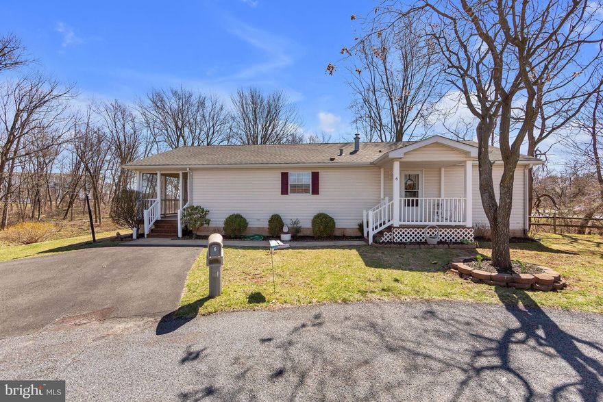 This Silver Manor model sits on one of the most premier lots in the Village of Willow Run. At the end of a cul de sac, this location affords a woodsy, bucolic setting with forsythia and bulbs planted by original owner. Wildlife is oftentimes seen while relaxing on this incredible porch running the full width of the house. This is a perfect opportunity to create a 3 season room. Entering the living room, one is immediately struck by the inviting, neutral paint color that exudes comfort and warmth. This model has a very easy, accommodating floor plan. Living room, with dining room “L”, to kitchen with an opening into hallway; that leads back to bedrooms and baths. Laundry room adjacent to kitchen with entry door from front of house makes coming in with groceries and packages very convenient; avoids traipsing through the living room. The large laundry sink with cabinetry is a welcome addition and one not often found. 2nd bedroom with bath directly across the hall is user friendly with tub and single sink vanity. Master bedroom is commodious with the opportunity to create a sitting area, desk space, TV and more than one dresser. Walk in closet and en suite bath with single sink vanity, step in shower, window and linen closet complete the picture. The Bilco door at the back of the house is a true benefit. Most homes in the village gain access through a bedroom closet. Should you want to increase water pressure, change cable location or simply check things are dry, this very real plus.