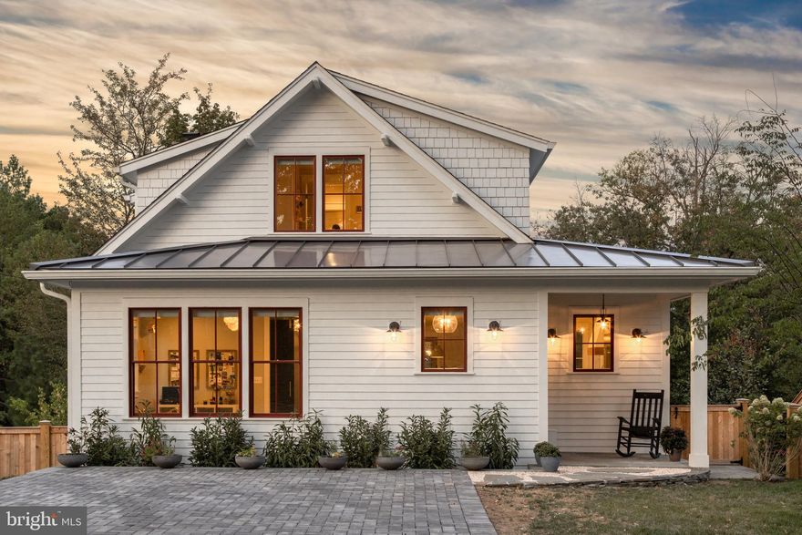Gorgeous and new custom home (2019) by Windmill Hill Design Build. Tucked away on one of Del Ray's quietest streets, this home is not to be missed. This brand new home features five bedrooms, three bathrooms, open floorplan, fabulous lighting,  gorgeous millwork and designer finishes. Enter into the mudroom with custom lockers that blend perfectly with the foyer. Head into the open main level where you will find a kitchen with oversized island, large dining area and a living room with a stone wood burning fireplace. From the living room, exit to the screened porch - perched atop a hill, you feel as though you are in a treehouse  - but with water views of the Potomac! The screen porch exits to a wrap-around deck with stairs connecting you to the rear yard. Rounding out the main level is a large bedroom, full bathroom and a spacious butler's pantry with wine refrigerator and extra cabinetry - great for all your entertaining needs! On the upper level you will find three bedrooms and two full bathrooms. The primary bedroom is spacious and full of light and features a walk-in closet and an ensuite bathroom with oversized shower. The two additional bedrooms feature beautiful touches like custom wallpaper, a built-in reading nook with sconces and a secret hideout accessed through the closet! The two bedrooms share a bathroom with tub and shower combination. Head to the lower level and prepare to be amazed. This level features a work-out area, large recreation room, bedroom with huge walk-in closet, spacious laundry room and abundant storage. The ceilings are all 9 feet, and this is a walk-out basement, so it is loaded with natural light. The recreation room has custom built-in shelves and is great for movie nights! Walk out to the covered bluestone patio from the rec room where you can relax or access the backyard! Park in the driveway and walk to all that Del Ray has to offer - this beautiful home has it all! Welcome home!