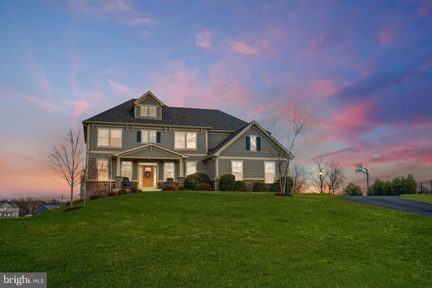 This is a rare opportunity to own a highly sought-after Ash Lawn model in Gladhill Estates! Located in the highly-coveted Urbana High School district, this home is situated on a 2 acre lot with great views and plenty of private space for playing and entertaining! With upgrades throughout--including engineered hardwood floors, and upgraded fixtures and lighting, this lovely home 
shows like a model! The modern, open floorplan features great spaces throughout–including a 
large office, formal dining room and an expansive family room–great for entertaining around the cozy gas fireplace. Chefs will love cooking in the gourmet kitchen with its granite countertops, loads of light grey shaker-style cabinetry, stainless steel appliances, dual ovens, and large center island/ 
breakfast bar! The smart, organizational features of this home won’t disappoint! The butler’s pantry/kitchen office center assures that you will never run out of cabinet space! The office center includes a beverage refrigerator, plenty of cabinetry and a built-in desk with room for two. Around the corner, you’ll find the mudroom with custom built-in locker organizers–a convenient feature! And a walk-in coat closet. The main level also includes a light-filled sunroom with a view. Enjoy outdoor living at its best as you walk out from the kitchen/morning room to the fantastic covered porch. Your guests will enjoy relaxing by the stack stone corner fireplace on the deck, too! (pre-wired for mounting your outdoor TV) On the upper level, you will find 5 oversized bedrooms with 3 full bathrooms. The spacious Owner's Suite features a full bump out sitting area--perfect as a quiet space for relaxing with a book or using as another home office space -- plus a spa bath with a large walk-in closet with space for two. The walk-out lower 
level is perfect for an in-law or teen suite and includes a full gourmet kitchen with granite 
counters and stainless steel appliances. The open floor plan features an eat-in dining area and spacious living area featuring a gas fireplace. The lower level also features a spacious bedroom–with plenty of natural light, an upgraded full bathroom and an enormous walk-in closet. Enjoy your morning coffee 
on the expansive two-tiered patio or relax in the hot tub! A white picket fence surrounds a portion of the patio and lawn. Minutes away from commuter routes, 
this home is a must-see!