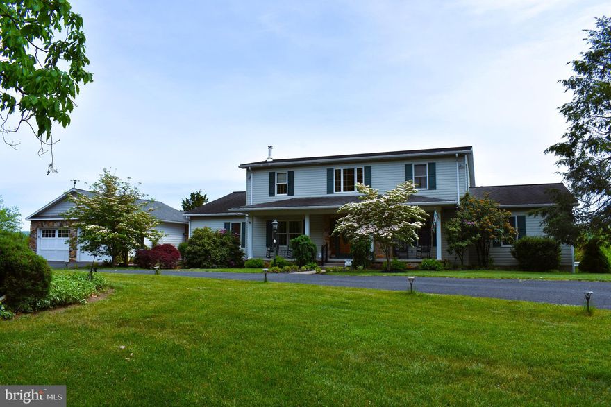 This custom designed and built, original owner home is a must see! The open floor plan main living area is fronted by a two story foyer and opens into a kitchen, dining, and great room area with gas fireplace, and a window wall to beautiful mountain views. The main floor also features a library with wood burning fireplace, powder room, and main level laundry. The main level boasts two bedroom suites. The primary bedroom features a walk-in closet, fully remodeled bathroom with walk-in shower and separate soaking tub, a sitting area with a cozy gas stove, and a deck to enjoy the view. The second suite on the other side of the living area is a very versatile space that is currently set up as an office. This space has a walk-in closet, en suite bathroom, and French door opening onto the sunroom. This space could easily function as an office, Mother-in-Law suite, craft area, or play room. On the second floor, there are two bedrooms, a bathroom, and a large loft area overlooking the main area below. This home also has a fully finished walk out lower level, with a living area, kitchen, bedroom, full bath, and patio area. There is a mechanical room with exterior access, and a single car garage finishing this level. In addition to all of the main living spaces of this home, there is a large sun porch area with a gas stove that connects the house to the main level two car garage. There is a covered grill area accessible to the sun porch and a large deck. All of these features and areas make this home great for entertaining. In addition to the amenities inside, there are four in ground cisterns with pumps collecting rain water for car washing, plant watering, etc. There is also a large carport for outdoor storage space for vehicles or equipment. This home enjoys the privacy of country living while being just minutes from UPMC Western Maryland, Allegany College, and Downtown Cumberland.