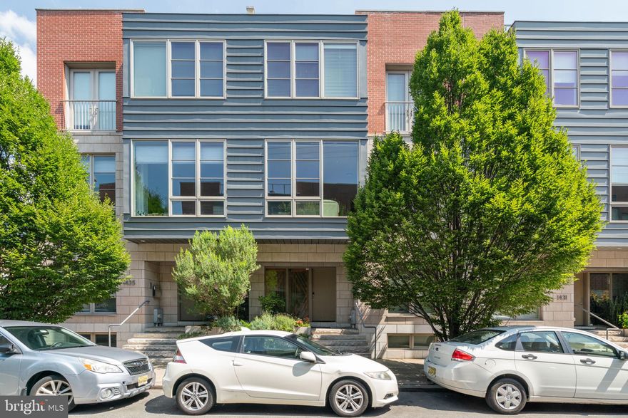 Spacious rarely available 24ft wide newer construction LEED Certified home featuring  4-bedrooms, 3.5 bathrooms in a secure gated community (No HOA), with extra wide 2-car attached garage, an elevator to every floor, 3 outdoor spaces, and is located in the Greenfield Catchment.  Designed with both style and functionality in mind, tall ceilings, recessed lighting, and beautiful hardwood floors throughout.  Enter to the modern and sunlit large foyer with ample space for clothes and shoes, and a separate bedroom that is currently used as an office. Full porcelain tiled hall bathroom and a convenient hallway closet. The private and gated driveway leads to an interior 2-car garage equipped with an EV Car Charger and built-in cabinetry. Travel up the  open center staircase to the second level which features a hallway coat closet and a half bath for guests. The dining area, adorned with abundant south-facing floor-to-ceiling windows, opens to the fully equipped kitchen, showcasing a center island with a breakfast bar, sleek flat panel modern European-style cabinets, and top-of-the-line appliances, including a 6 burner 36” Wolf oven, range, and microwave, a SubZero refrigerator, an under-counter SubZero wine fridge, dishwasher and even a built-in Miele espresso maker. Expansive living room with a wall of glass doors that open up to a composite trek deck spanning the width of the home. This outdoor space offers ample room for a grill, couch, lounge chairs, and dining table. Third level with primary bedroom, three closets all fitted with built-ins, primary  bathroom features a double-wide tiled shower with a stone floor, double vanity with ample storage, and a private water closet with its own vanity and additional storage space. This floor also includes two more generous bedrooms with excellent closet space, and a hallway bath with a soaking bath/shower combo, full tile surround and a conveniently located hallway washer and dryer. The fourth level reveals two roof decks! One overlooks the Center City skyline, while the other faces south, perfect for entertaining!  The lower level of the home features extra-tall ceilings and two additional living spaces!  Currently used as a gym and home theater but can be whatever suits your needs. Conveniently located within a short walk to Rittenhouse Square shopping, restaurants, the Avenue of the Arts and all Center City has to offer!