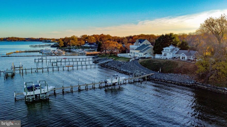 Your new life awaits.....Welcome to 2329 Tickwood Road in Essex!  This is waterfront living at its finest offering panoramic vistas, unparalleled sunrises, and breathtaking skies.  With 140' of waterfrontage, you have unobstructed views of Pooles Island, the Eastern Shore, and the Chesapeake Bay. The home sits 75 feet above sea level, one of the highest peaks at the mouth of Middle River.  Nestled on a peaceful road past its own gated entrance, you will be at ease with the privacy Tickwood provides. Just a few steps outside and you'll find the property abuts to Turkey Point Park, perfect for quiet morning walks.
The home itself was originally built in 1941 and has expanded and been renovated over time to its now 3613 sq. ft.  finished living space.  With large and numerous windows throughout the home, the view of the water is never far away.  The property features five bedrooms and four and a half bathrooms. Take comfort to the next level with the sumptuous water view primary bedroom suite with luxury full bath which includes a soaking air-jetted slipper tub, dual vanity sinks, and large separate shower.   The family room is large enough for entertaining yet cozy enough to enjoy an evening fire in your fireplace all while viewing the water from the large picture window.  The Kitchen is another focal spot of the home with the solid wood cabinetry, upgraded granite countertops, stainless appliances, Walk-in Pantry, and seating area with panaromic water views.  The outdoor space has been thoughtfully designed as well.  The composite deck features an 18-foot Pool/Spa that can be heated to function like a Hot Tub, perfect for those chilly nights.  The rest of the yard is paved creating multiple patio and seating areas for endless outdoor entertaining. Iron fencing encloses the backyard area for more privacy.  From here, the walkway laces down to the 200 ft Pier. You'll find 4 boat lifts here for the avid Angler.  The largest lift accommodates 25,000 pounds of load and provides 30 and 50 amps of service.  The next can lift 12,000 pounds with 110V power.  The other two can be used for smaller boats, jet skis, etc.  There is a fishing station, separate electric panel, and water hose access.   By water, you are only a few minutes to Hart Miller island, the entrance to the Chesapeake Bay, a little further and you are at Tolchester Marina and Beach. 
The home is situated on 1.06 Acres which was originally 2 lots.  The back grassy area used to have a small cottage for visitors.  There is a large Shed on the property for all your storage needs and an oversized attached 2 car garage.  There is a crushed stone circular driveway and additional spots for multiple car parking, an entertainer's must-haves. 
Your new life awaits at 2329 Tickwood Road.  Don't wait to act on your dream lifestyle.