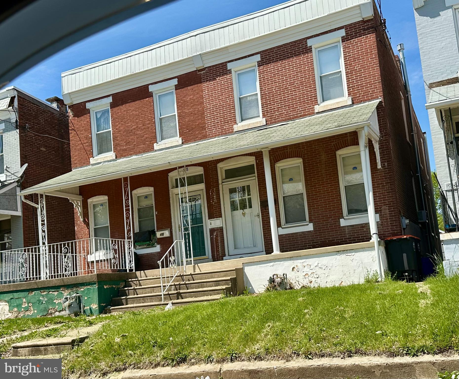 Larger than most twin homes at 1,828 sq ft. The first floor features a vestibule entrance leading into a spacious living room and dining area. A half bath has been added with an extra-wide door opening. Character is evident in the wooden staircase's banister. There is a door at the top of the staircase on the second floor that connects to the first-floor dining area. This door is currently inoperable, and the staircase lacks lighting. The second floor includes three well-sized bedrooms and a completely new bathroom.
The home also has a large, full, unfinished basement. Additionally, there is a garage located in the back alleyway.
A handicap ramp is available through the back door, and a ramp in the kitchen provides access to the first floor only.