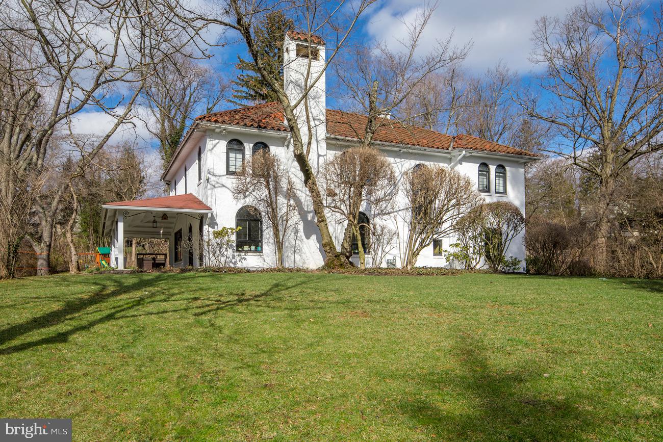 Virtual tours are available! No in-person tours until the shelter in place order is lifted. Please contact the Listing Agent for more details. Check out our video tour: https://www.youtube.com/watch?v=jvt8R1nSO1g | This beautiful 4 bed, 3.1 bath Mediterranean-style stucco home, set far back from the road and approached from a gated drive, sits on spacious private grounds and is timeless in style & elegance. Lush property is met by gracious interiors that have been totally and tastefully redone, and make a perfect backdrop for today s discerning family. Among the many refinements and improvements include upgraded fixtures, upgraded wiring, newer Pella windows, the addition of LED recessed lighting, 3-zone HVAC, a fully renovated kitchen, redone bathrooms, original marble flooring, and a whole house natural gas generator. A marble entry brings you inside to a dramatic 2-story reception hall featuring a stunning spiral staircase focal point, with a fully-outfitted coat closet and powder room nearby. Large arch openings lead into a generously-sized living room with a gas fireplace, oversized arched windows and striking doorways to a private covered patio. Off the living room sits a lovely sunroom brightened by a wall of windows. Pocket doors open to the formal dining room creating a great flow for entertaining. Abundant light pours into the dining quarters with original built-ins from huge windows overlooking the flagstone patio. More arches spill into a gorgeous renovated chef s kitchen appointed with porcelain flooring, quartz countertops, subway tile backsplash, pantry, and stainless steel appliances including 2 ovens, refrigerator & dishwasher by Jennair. The built-in breakfast booth is an ideal spot for morning coffee and casual fare. A door to the rear patio affords easy indoor-outdoor serving. Also from the kitchen, you can access covered entry to the 2-car garage as well as rear stairways that lead up to the playroom and down the basement. A sunny office with hardwood floors, original windows & built-in shelves/cabinets provides a quiet place to work. Up the staircase to the 2nd floor landing with refinished hardwoods is the master suite, 3 additional bedrooms, and a playroom. All rooms are carpeted & well-proportioned, and all 3 baths (2 en-suite) have been impeccably redone with radiant heated floors. The master is equipped with a massive custom walk-in closet and private hall bath with double vanity, tub & steam shower. Atop the garage is a wonderful vaulted playroom for fun & games with light pouring from window walls on both sides. An unfinished lower level houses laundry and gym equipment and has lots of possibilities. The flat tree-lined backyard offers plenty of space for swings, sports & recreation. Best of all is the convenient location near the Wynnewood shopping area, Suburban Square, train to Center City & major routes.